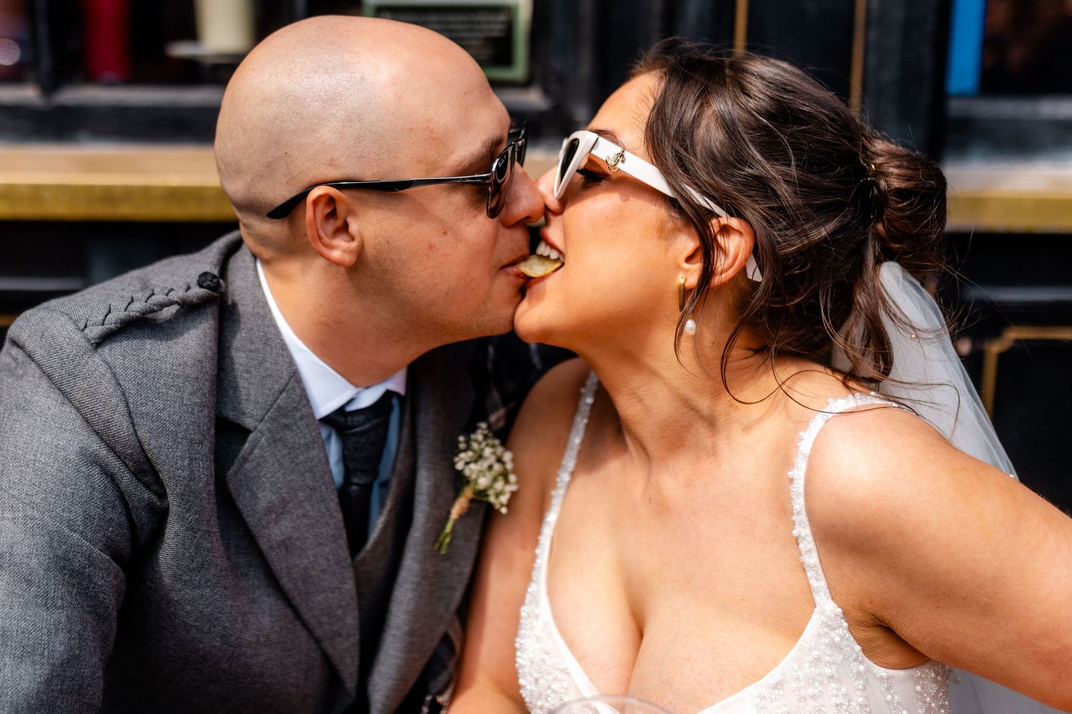 Crisp sharing bride and groom, fun photos, Edinburgh City Scotland,