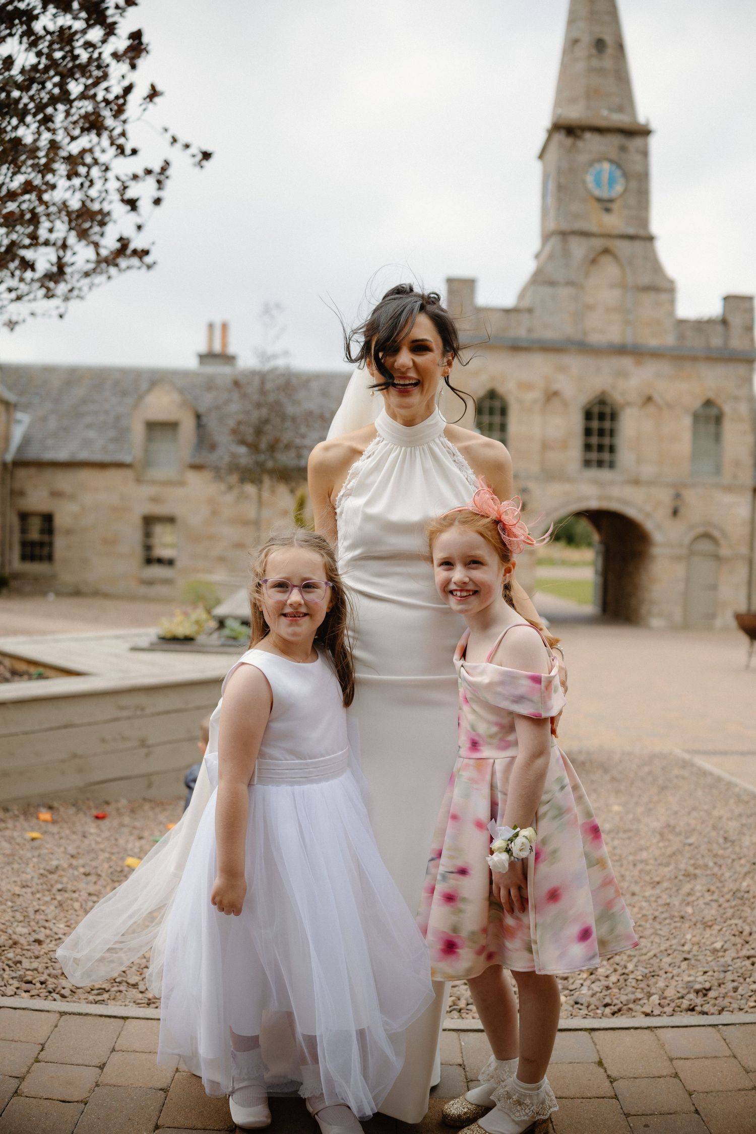 Wedding bride with kids courtyard at Rosebery Steading, Temple, Gorebridge, Scotland.