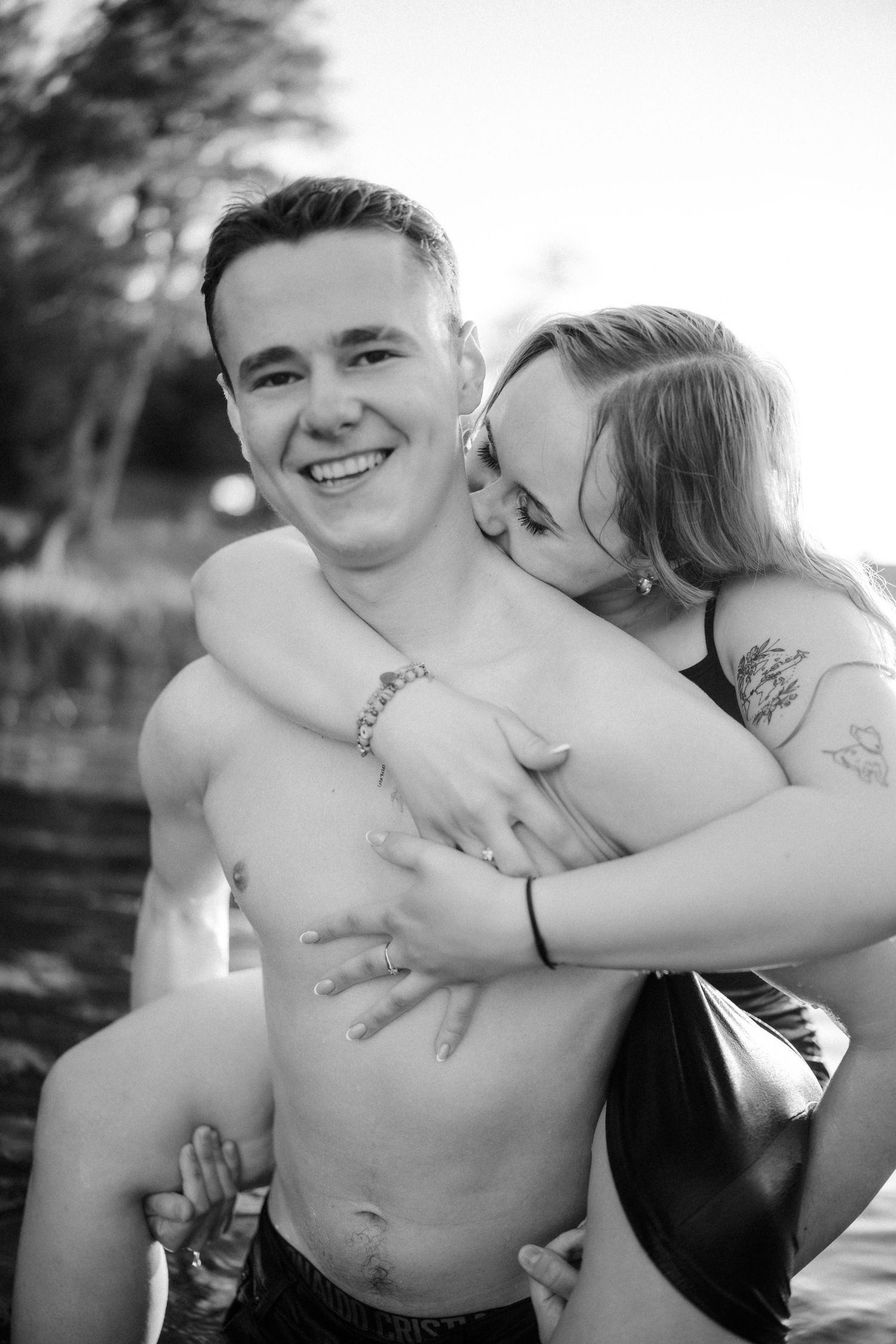 Black and white portrait session capturing intimate moments at the beach.