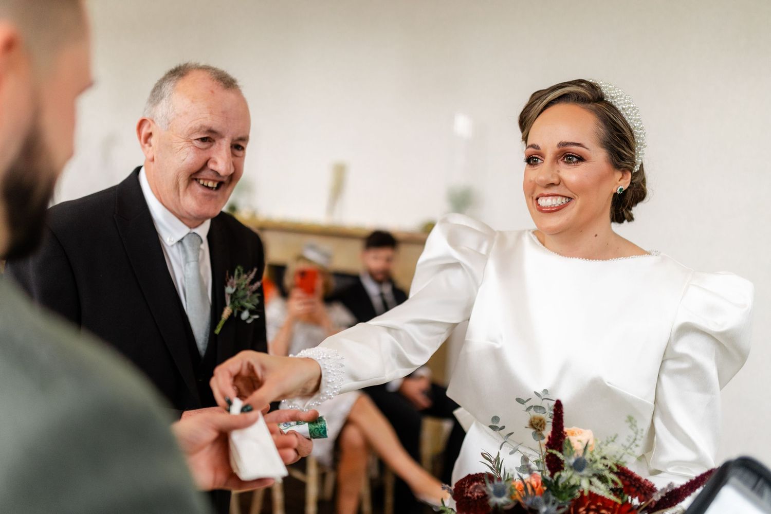 Wedding reception celebration with guests enjoying festivities indoors.