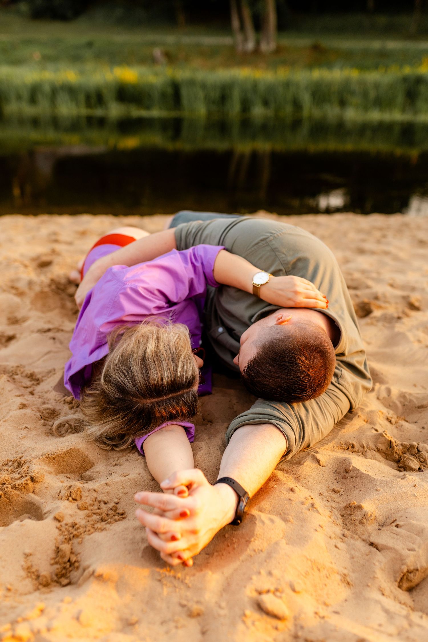 Intimate moments captured on a sandy beach during golden hour.