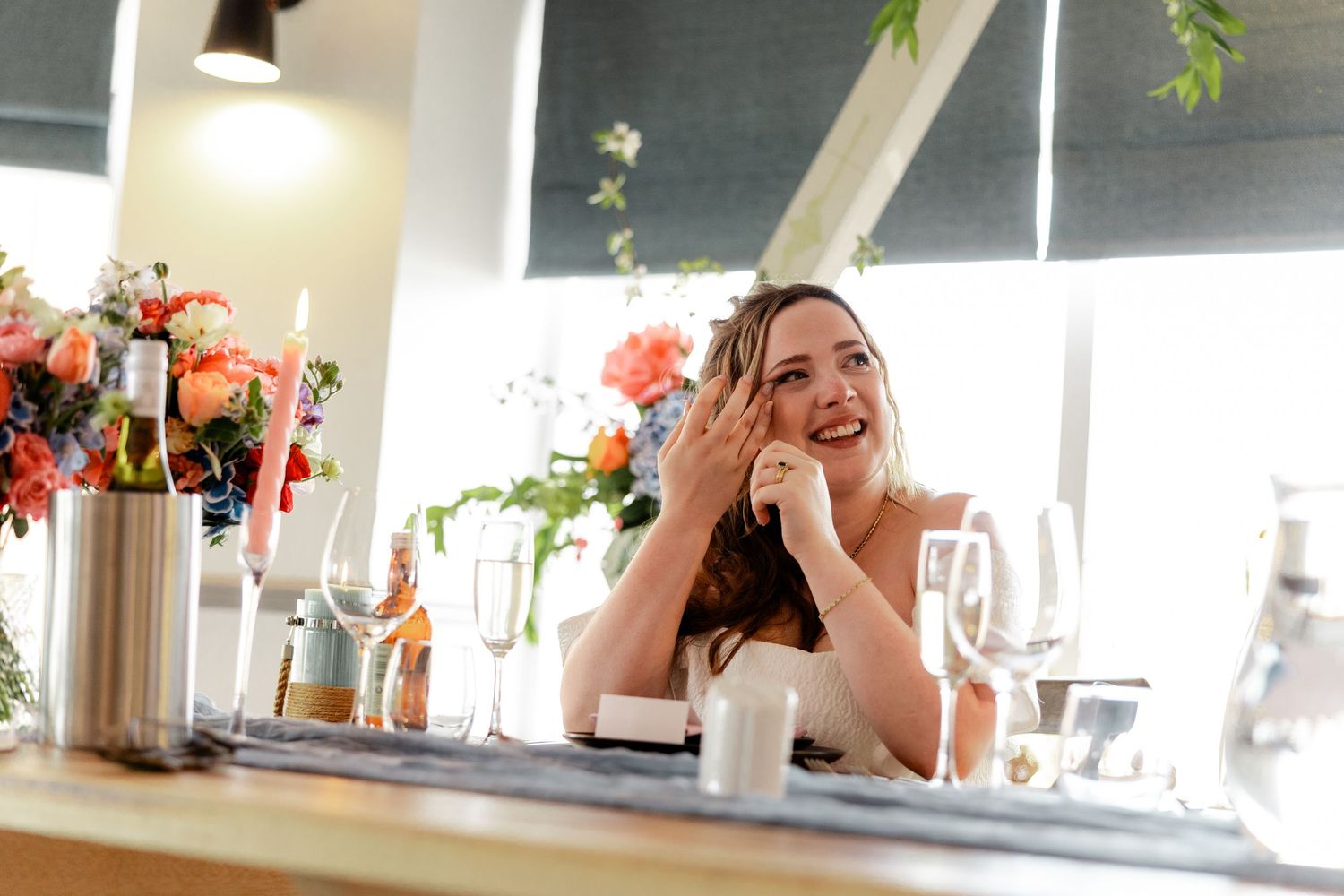 Candid moments of joy and laughter during a wedding celebration.