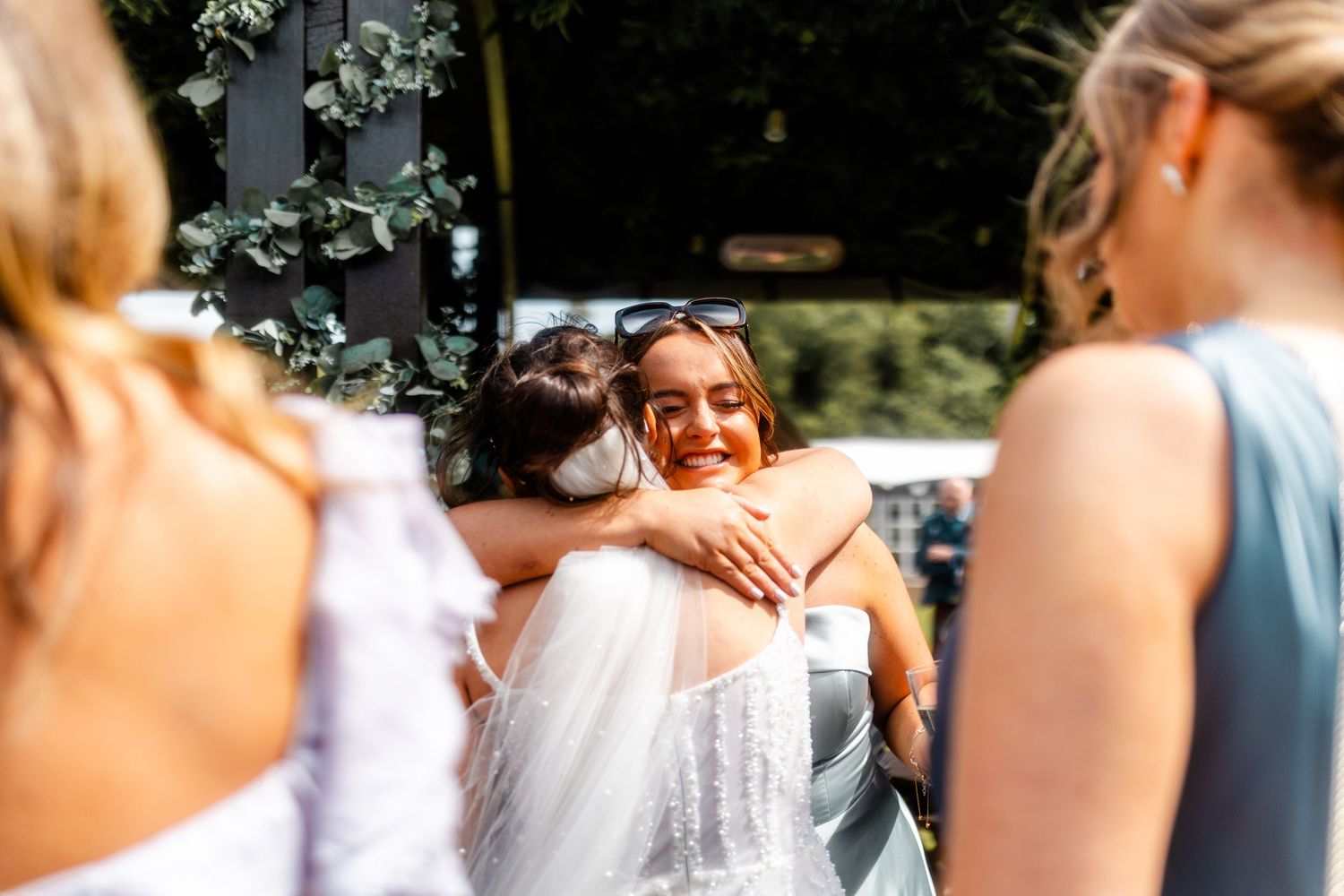Wedding guests hugging outside of Glass house Edinburgh, Scotland.