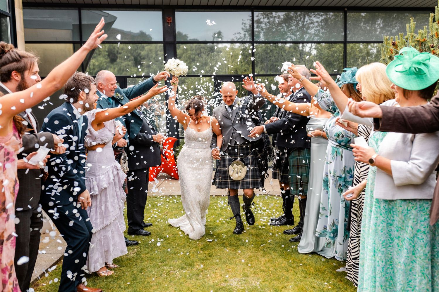 Confetti toss, bride and groom with guests, wedding Glass House Edinburgh, Scotland,