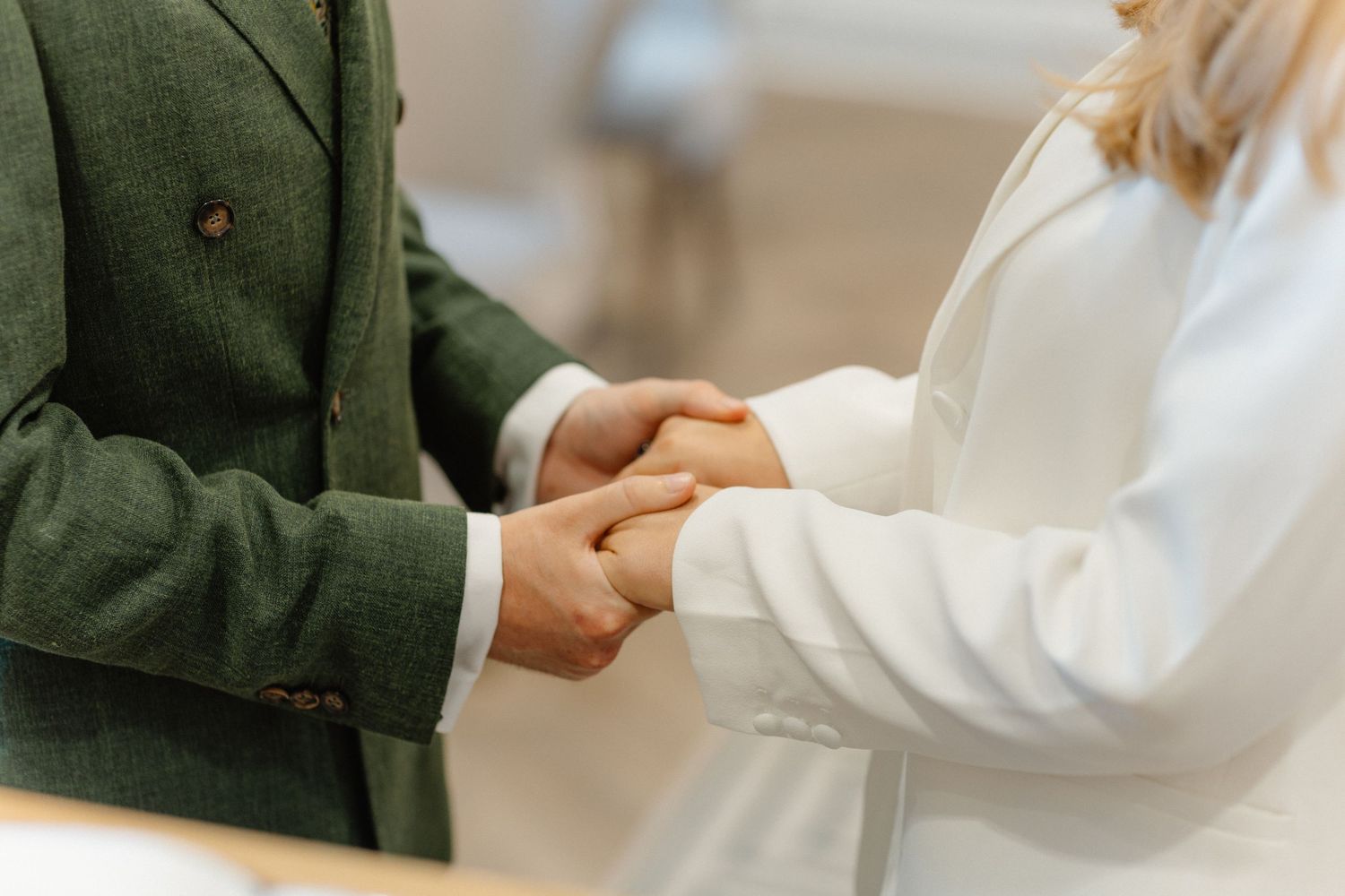 A couple sharing an intimate moment in a white and green color scheme.