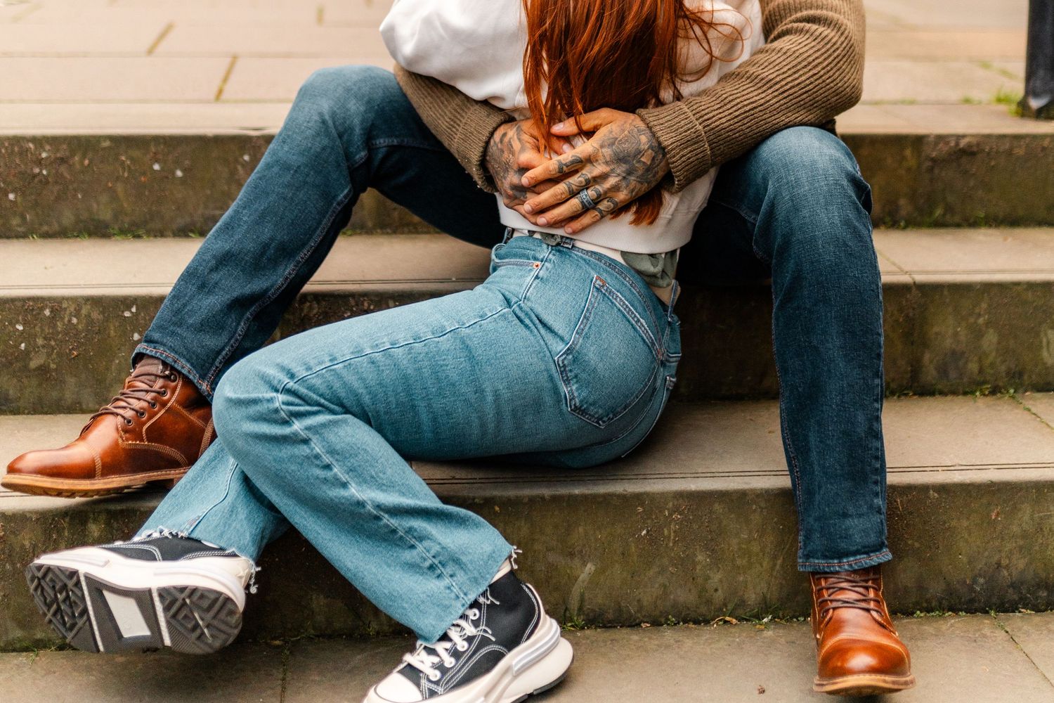 Close-up sequence of casual clothing and shoes on concrete steps.