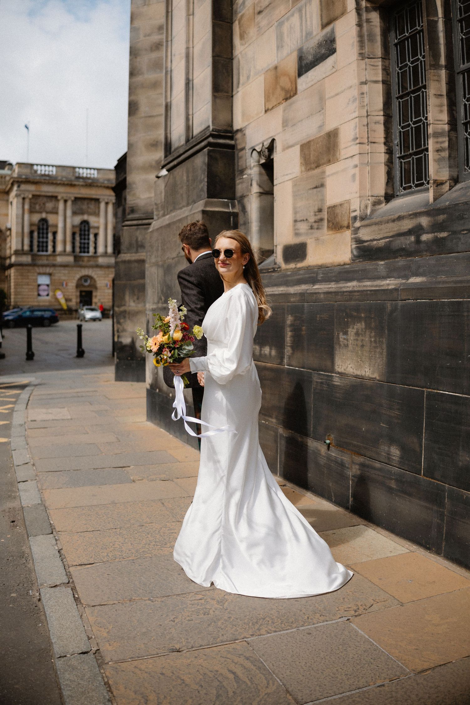 Bride and groom walking around the city  in Edinburgh Scotland