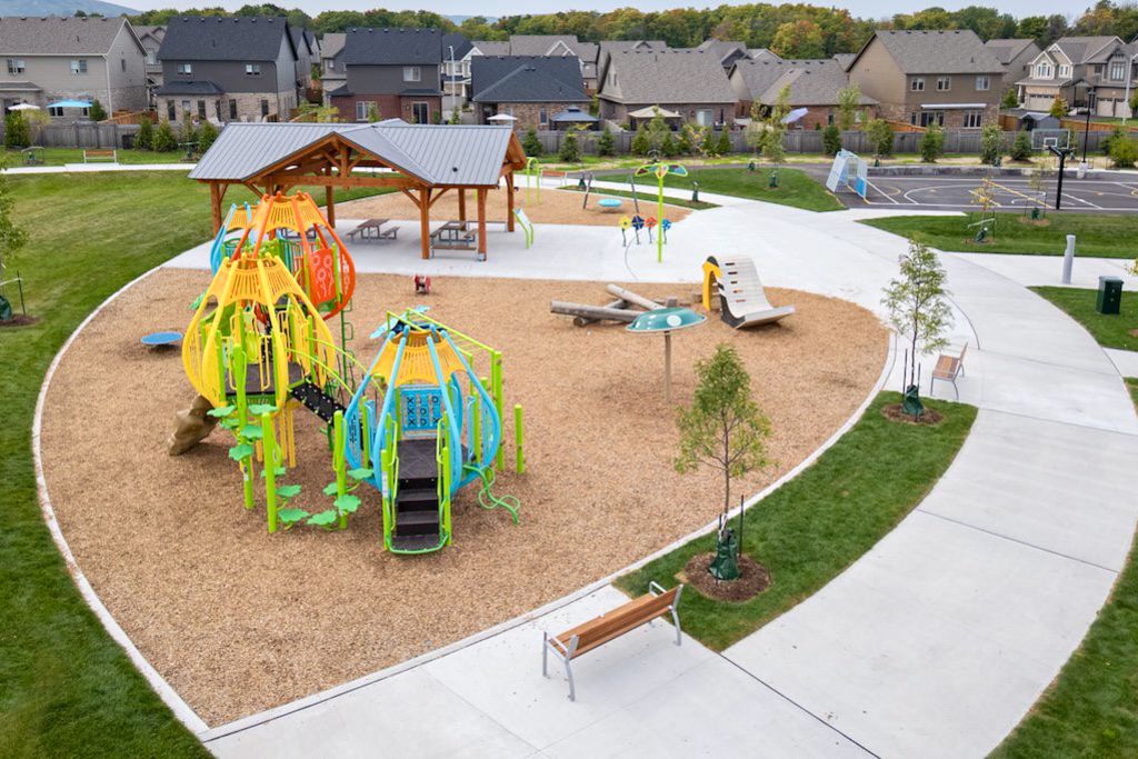Aerial view of a colourful children's playground with wood chip surface in a suburban park in Collingwood Ontario