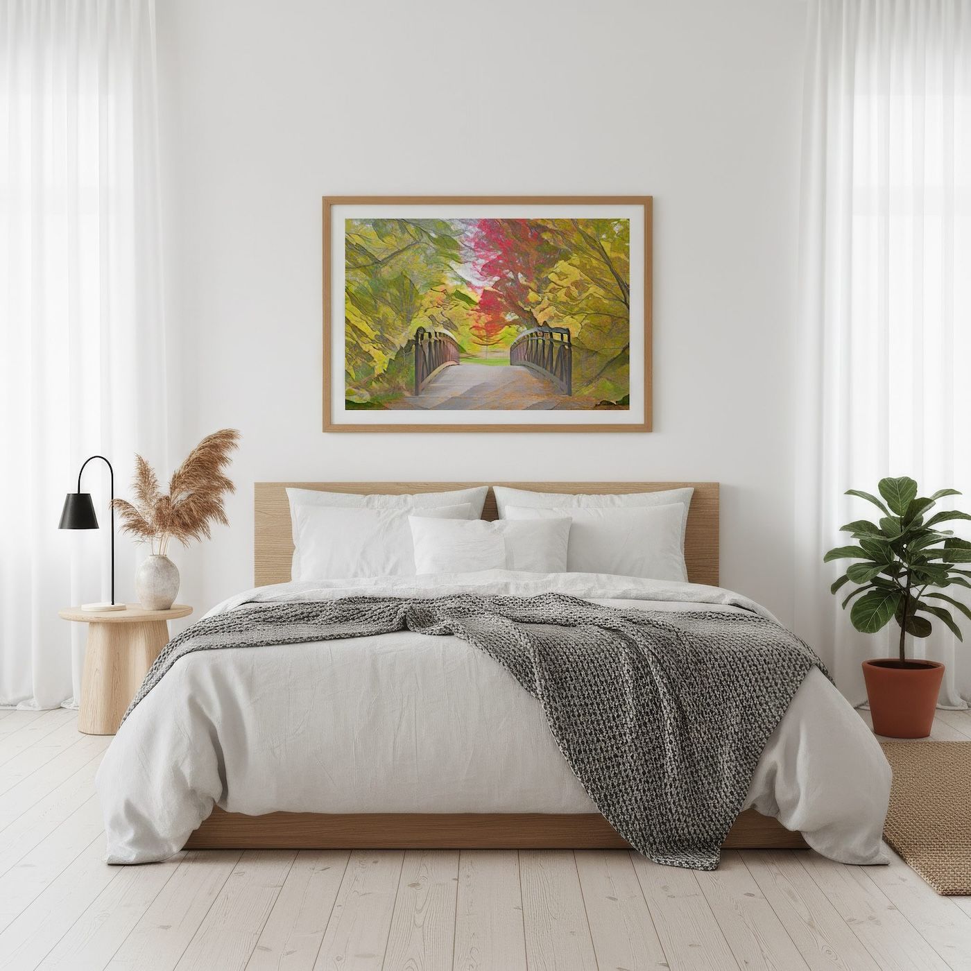 Vibrant autumn bridge painting in wooden frame above white bed in bright minimalist bedroom.