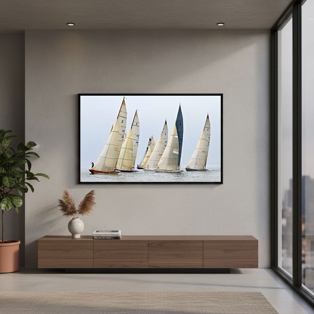 Large canvas print of sailboats racing at sea displayed above modern wooden TV console.