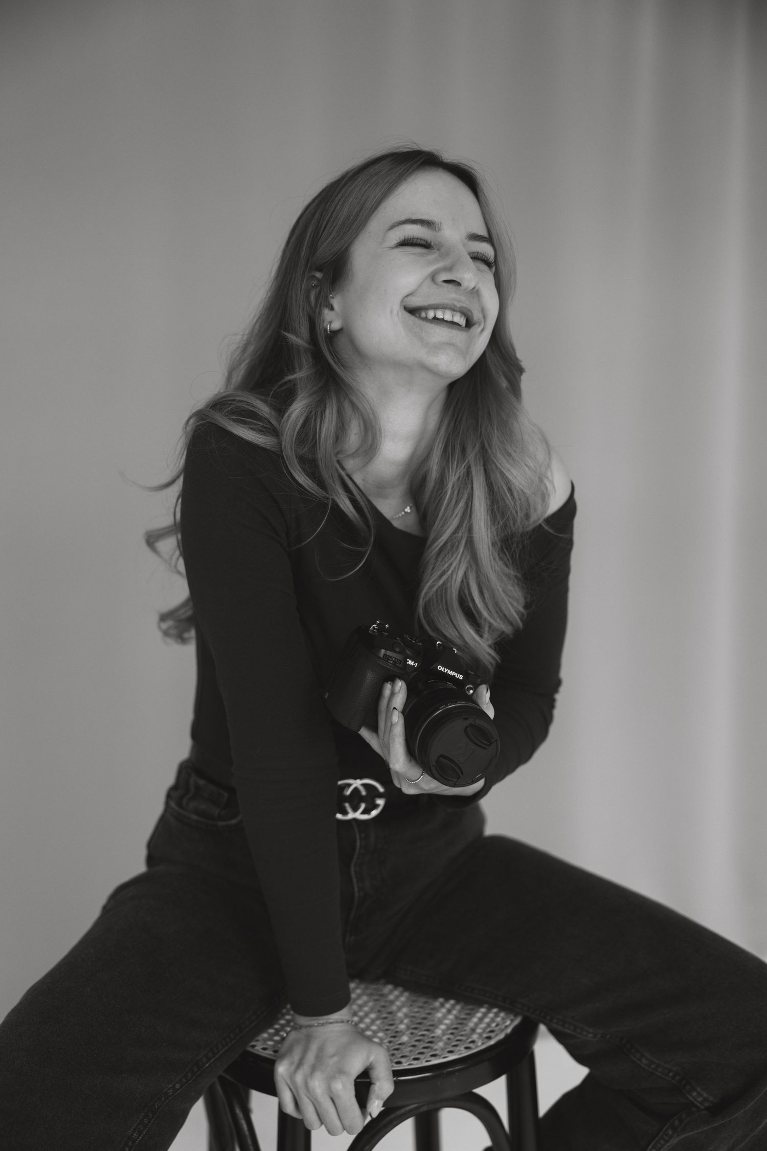 Black and white portraits showing joyful laughter and genuine emotion in a studio setting.