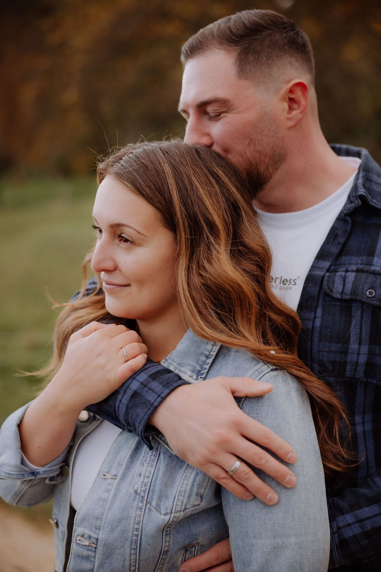 A romantic couple embraces outdoors in autumn, shown in a series of intimate candid moments.