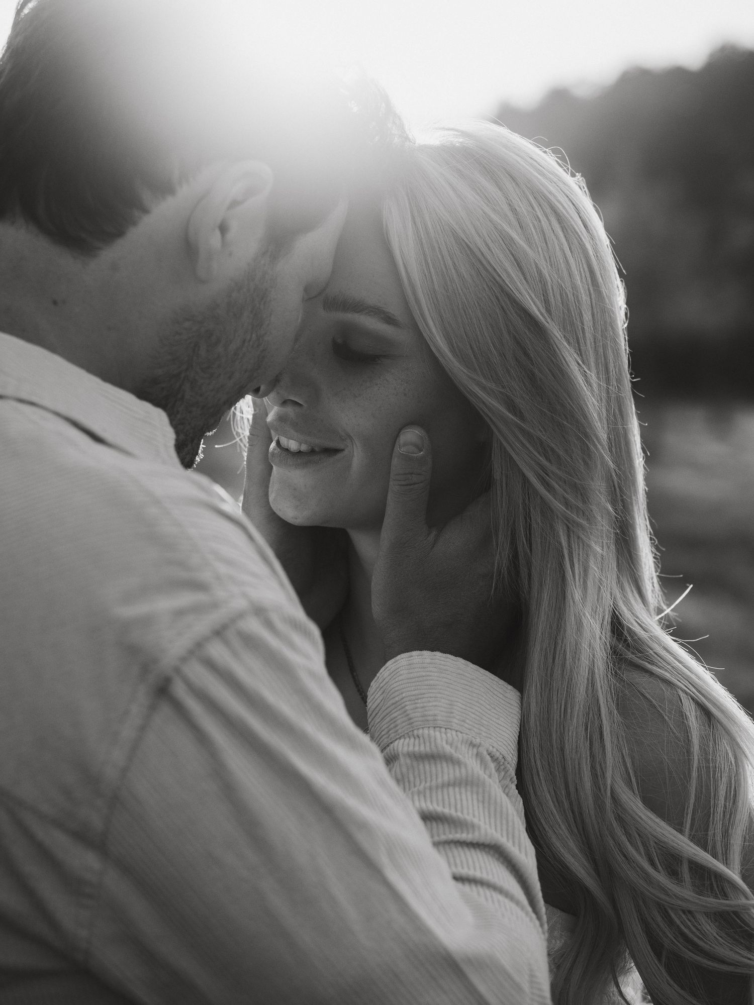 A romantic black and white photo sequence showing a couple embracing and sharing intimate moments outdoors.