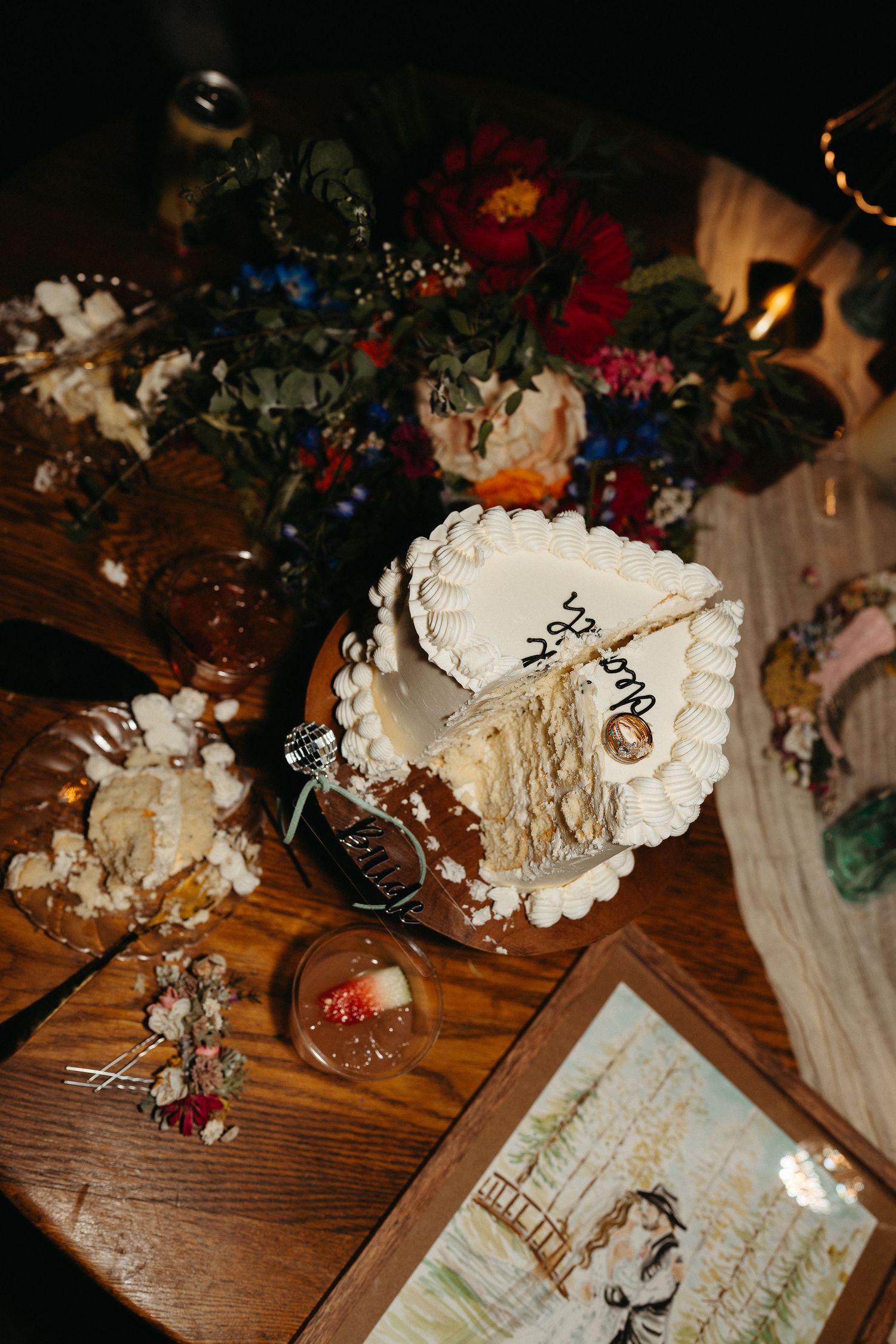 Vintage book pages and white floral decorations arranged artistically on a rustic wooden surface.