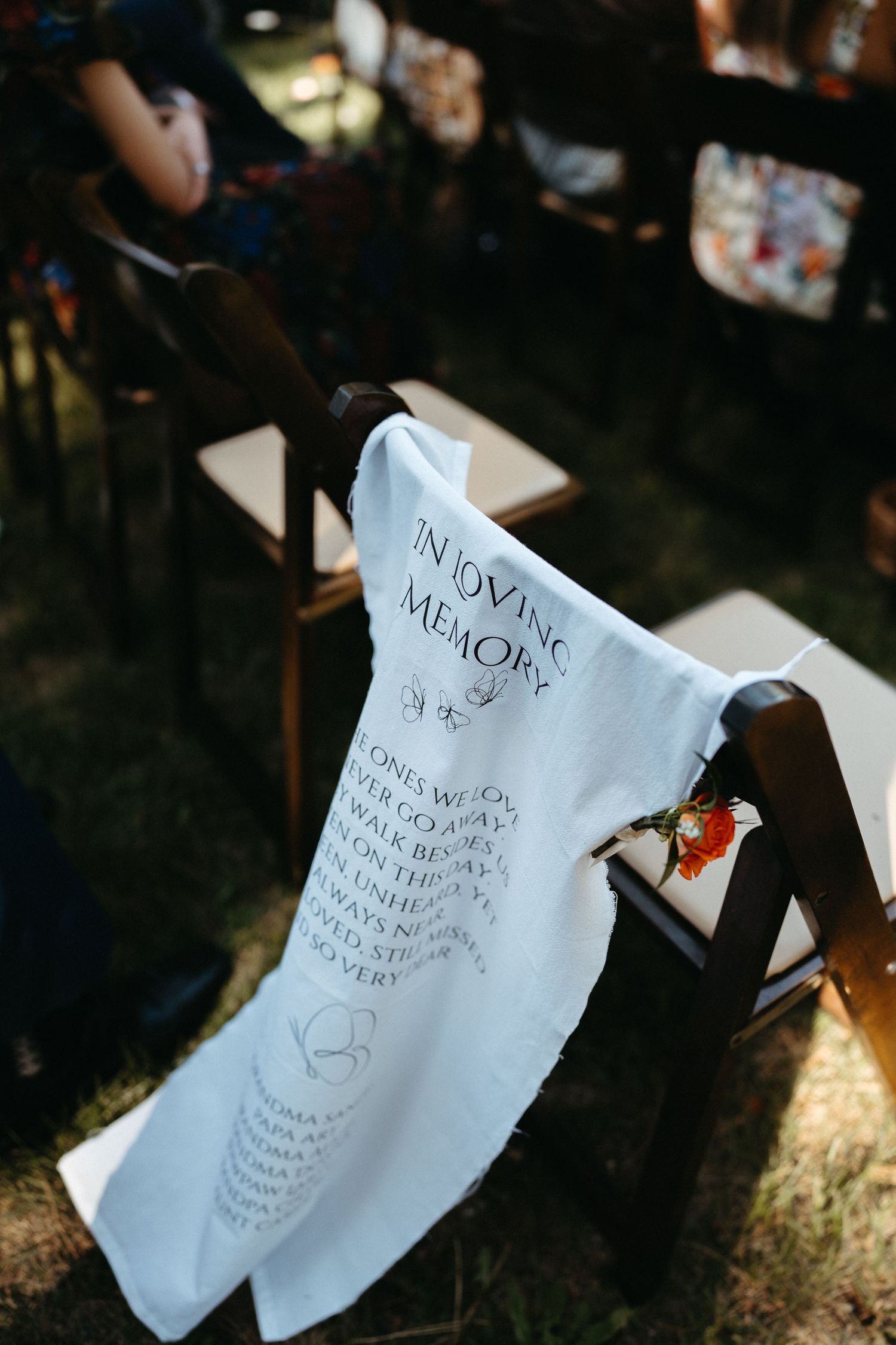 Wedding vows written on white paper displayed in natural outdoor lighting during ceremony.