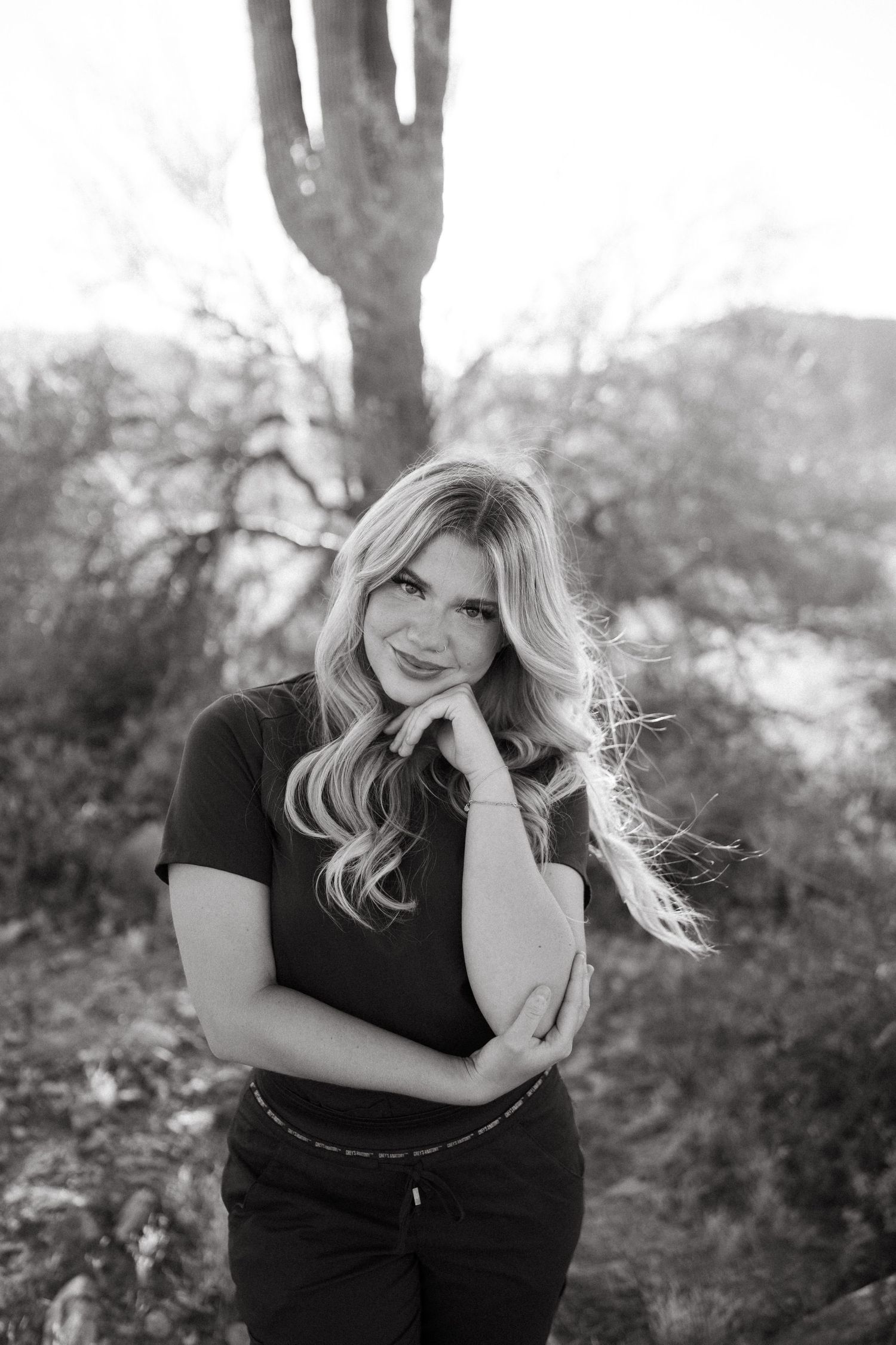 Portrait in desert setting with saguaro cactus silhouette in black and white.