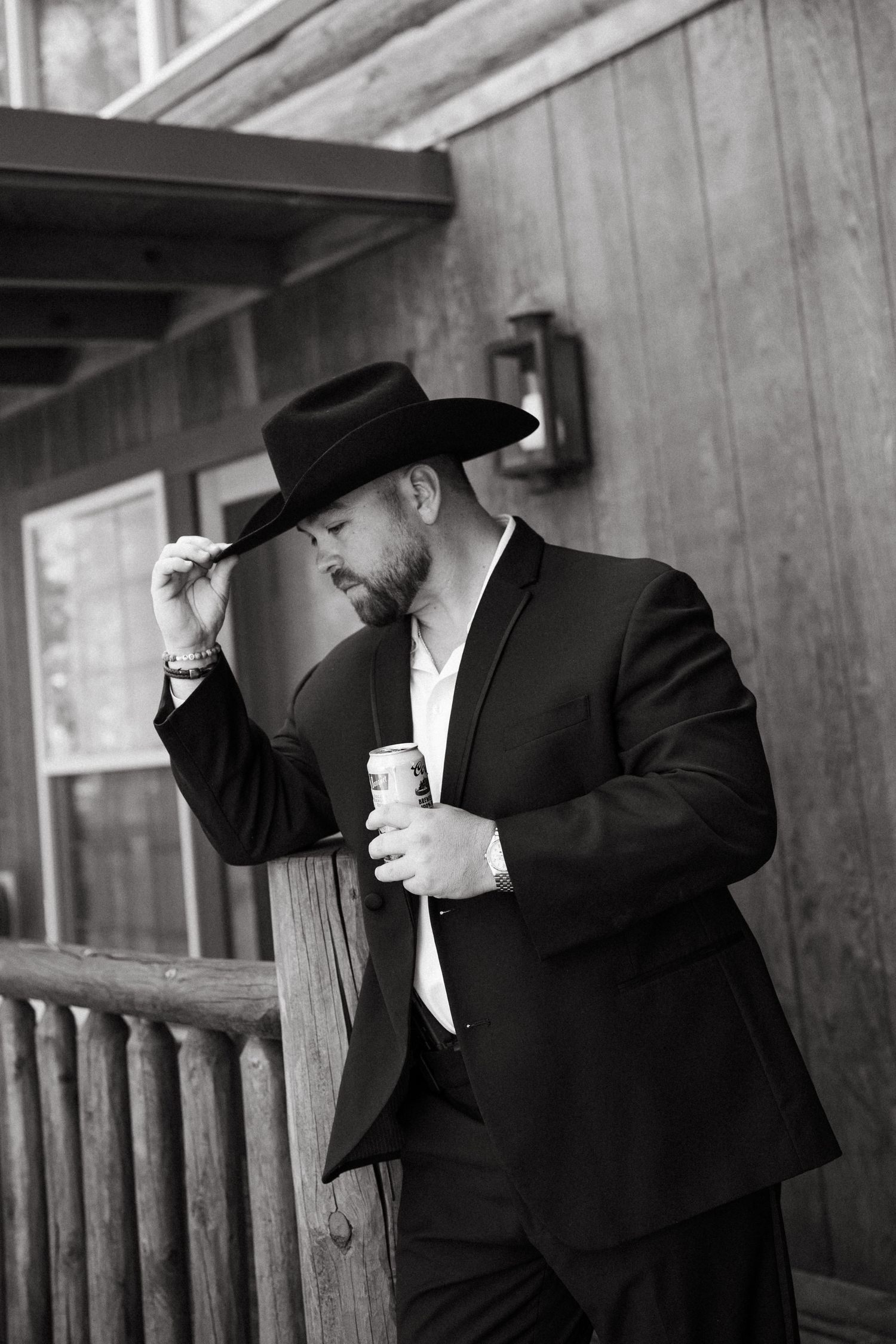 A black and white photo series showing men in traditional Orthodox Jewish attire adjusting their hats on a porch.