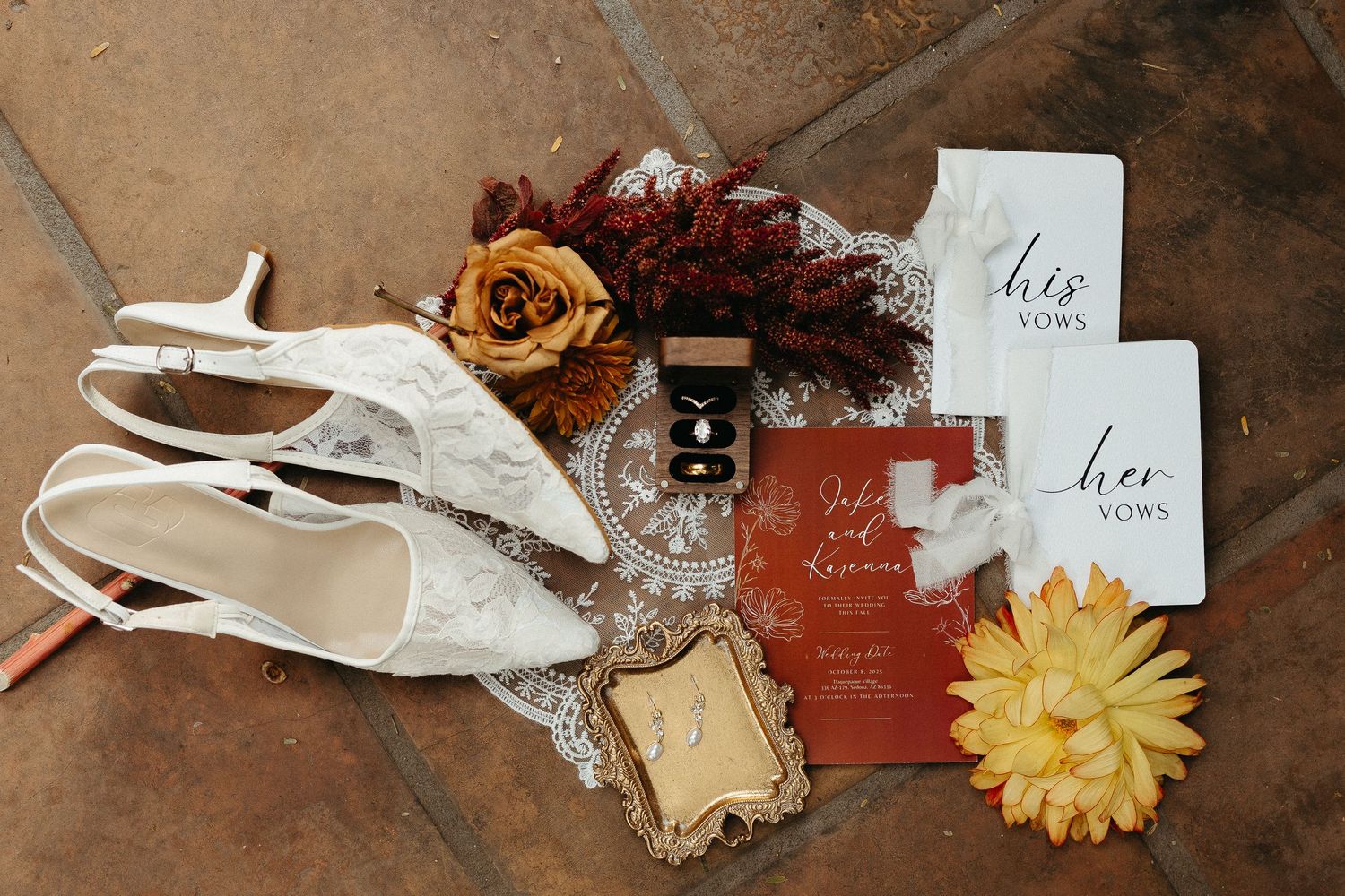 A collection of white paper airplanes arranged with dried flowers and vintage papers on a rustic wooden surface.