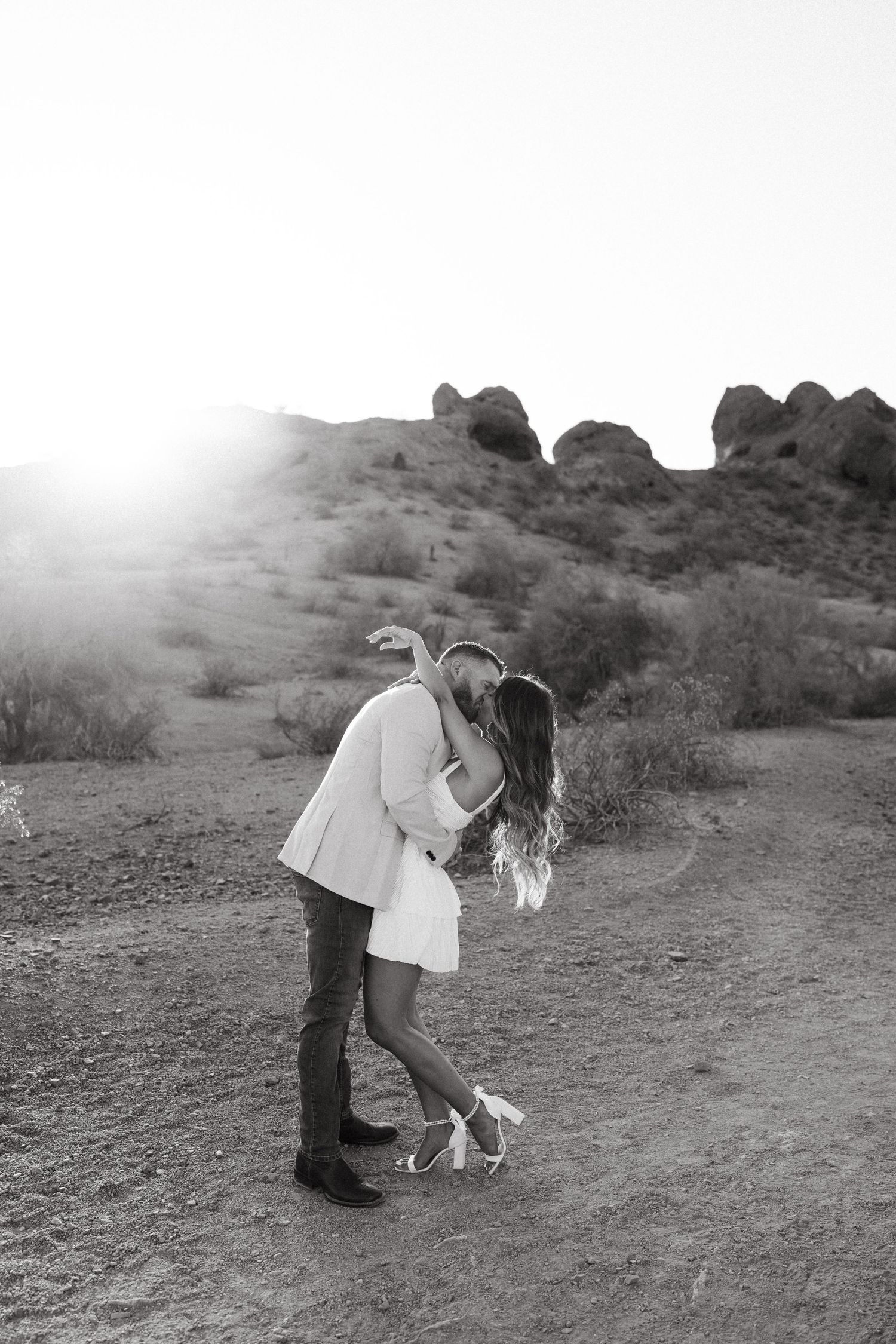 Multiple sequence photos show a person bending down to collect something in a desert landscape setting.