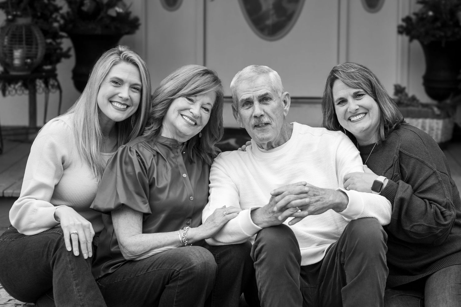 A series of black and white photographs showing a family sharing candid moments together on a couch.