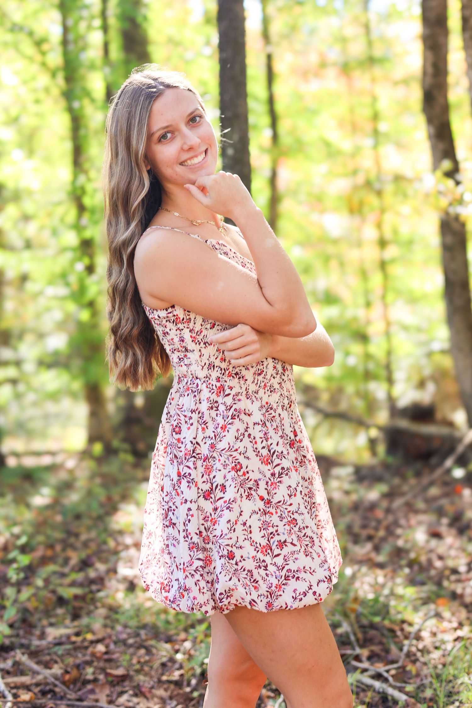 Candid outdoor portraits in floral dress among fall foliage.
