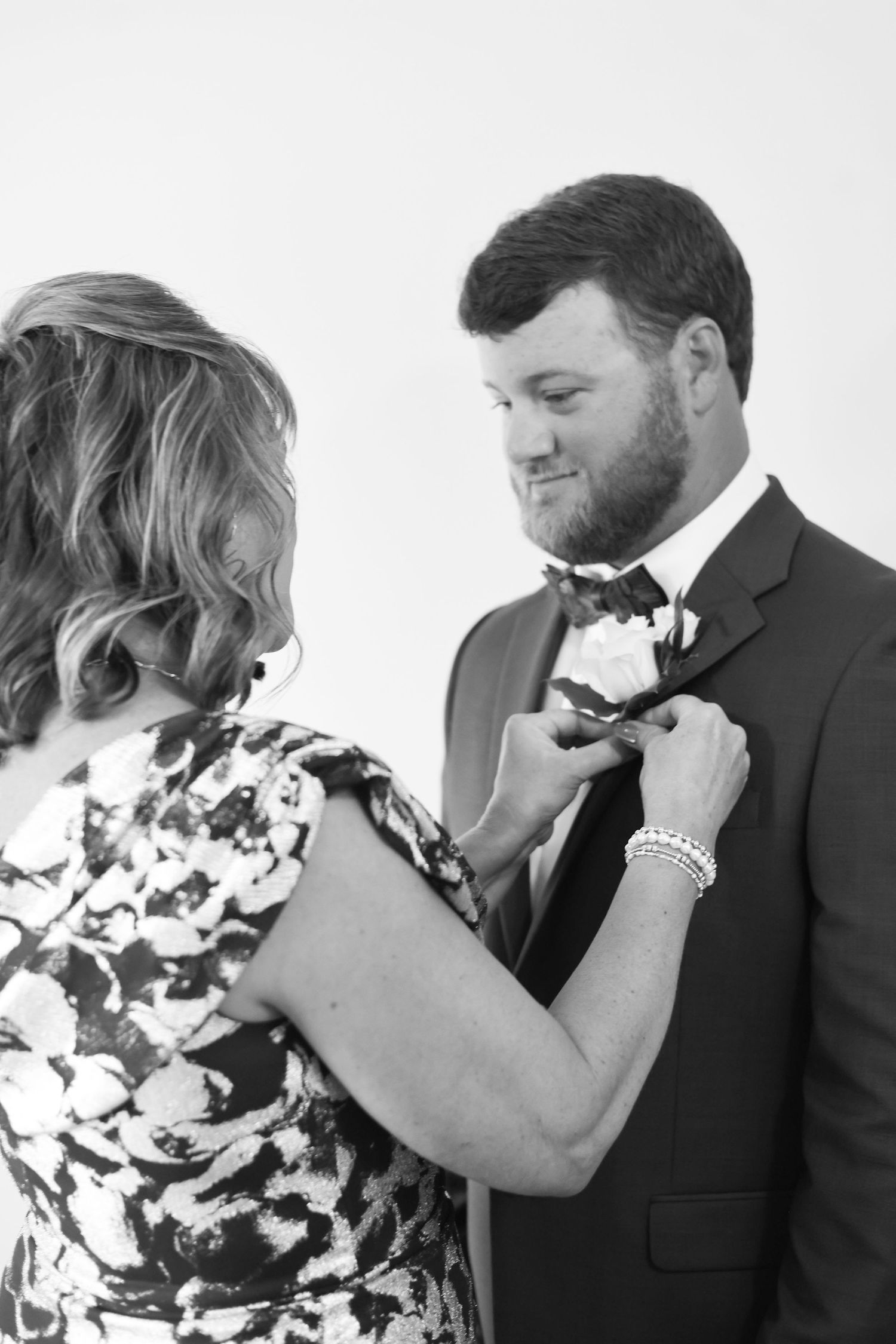 Black and white candid wedding moments showing emotional reactions during a ceremony.