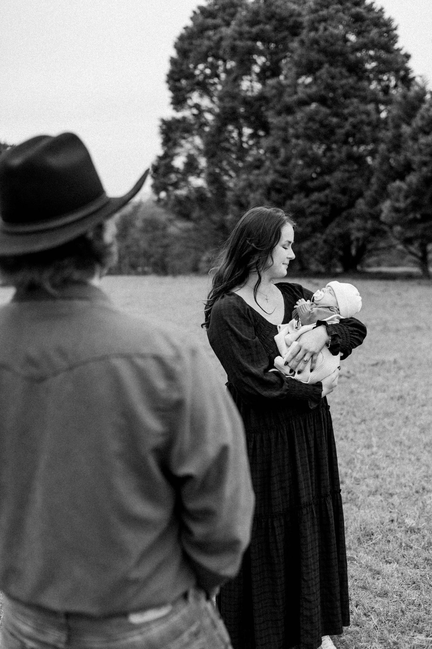 A series of photos showing parents bonding with their newborn baby outdoors.