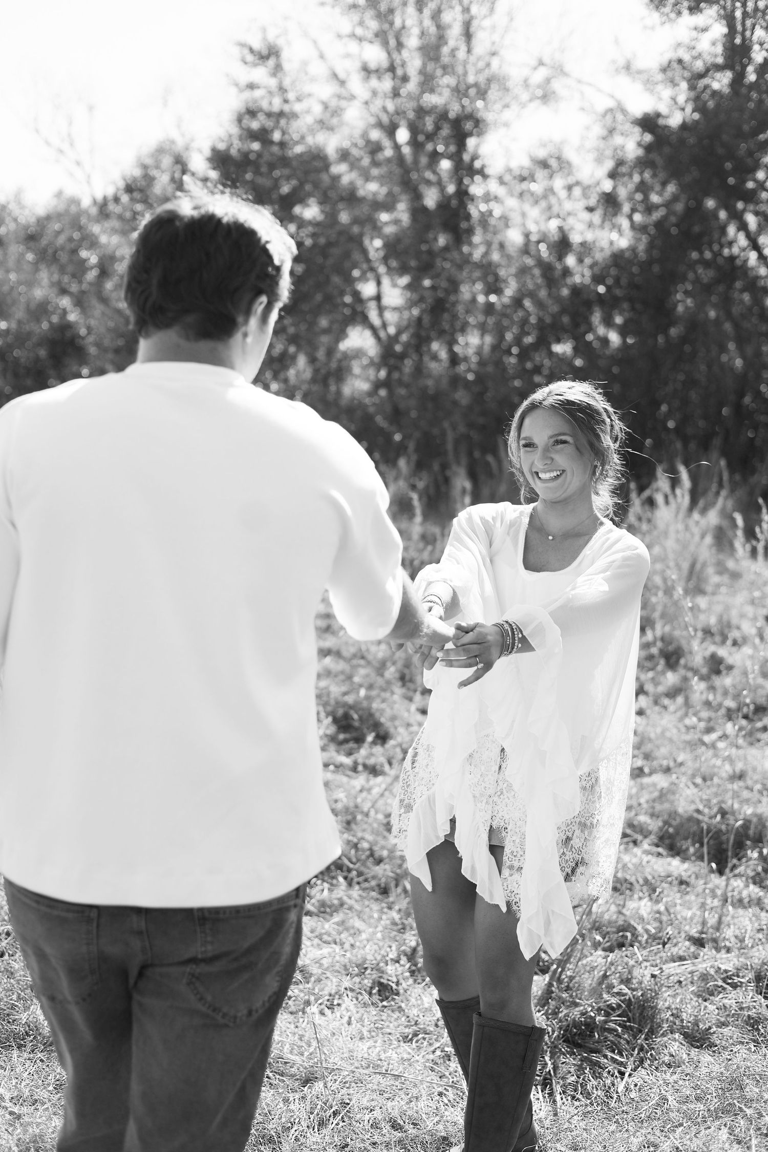 A series of black and white photos showing people in white shirts walking through a sunny field.