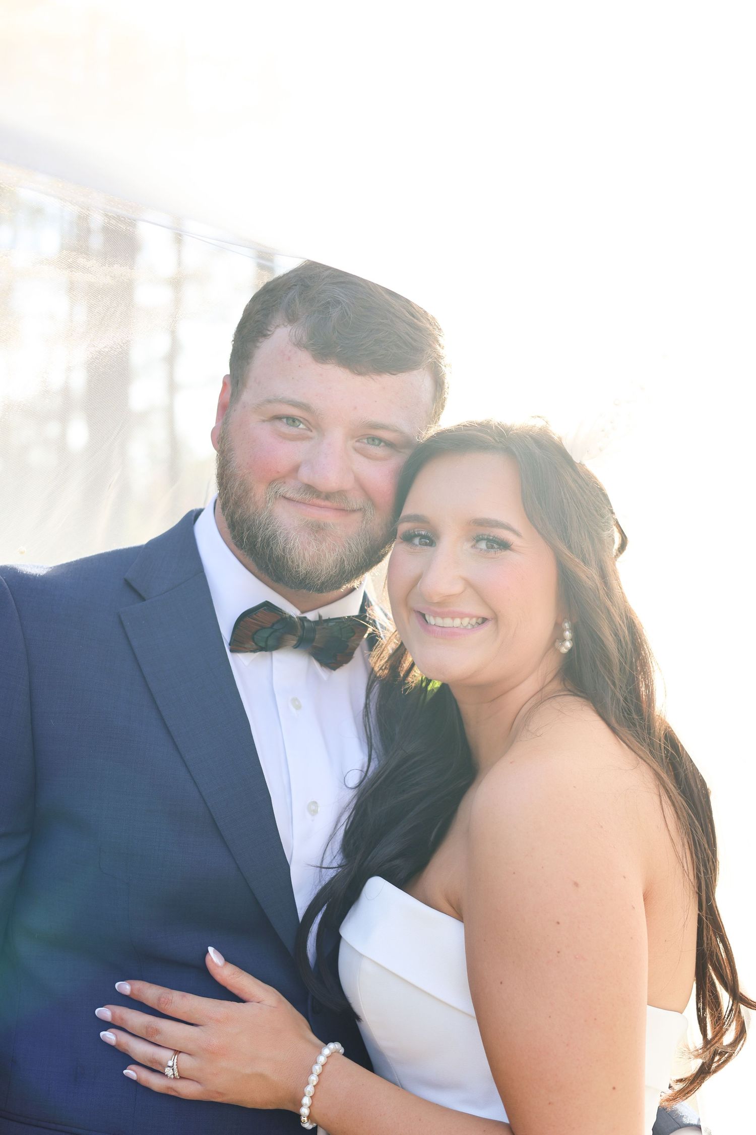 Sun-drenched wedding portraits capturing joyful moments between newlyweds.