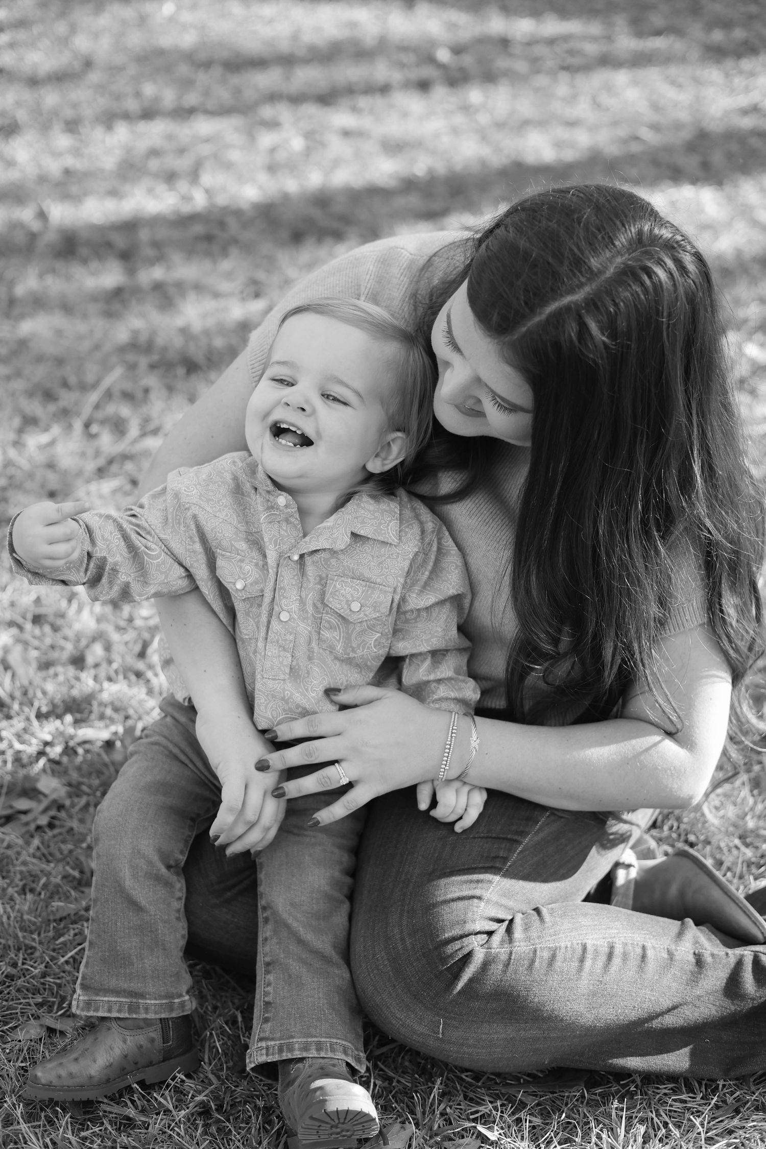 Black and white candid photos showing playful moments outdoors on a sunny day.