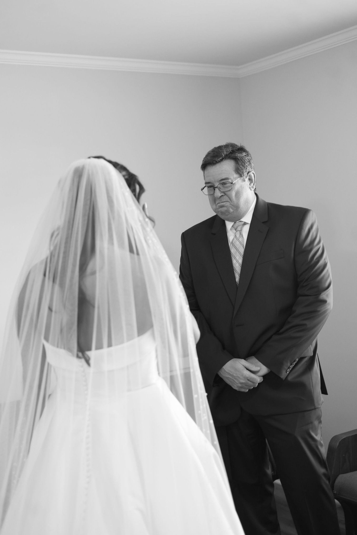A sequence of emotional wedding day moments shows a bride in a flowing veil with her father before the ceremony.