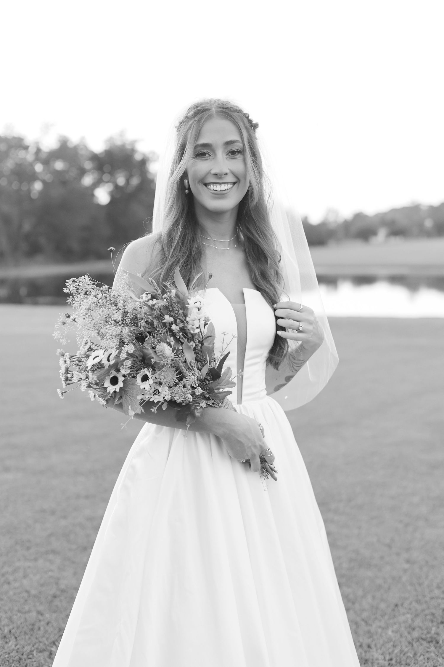 Black and white bridal portrait series showing joyful moments with rustic wildflower bouquet.