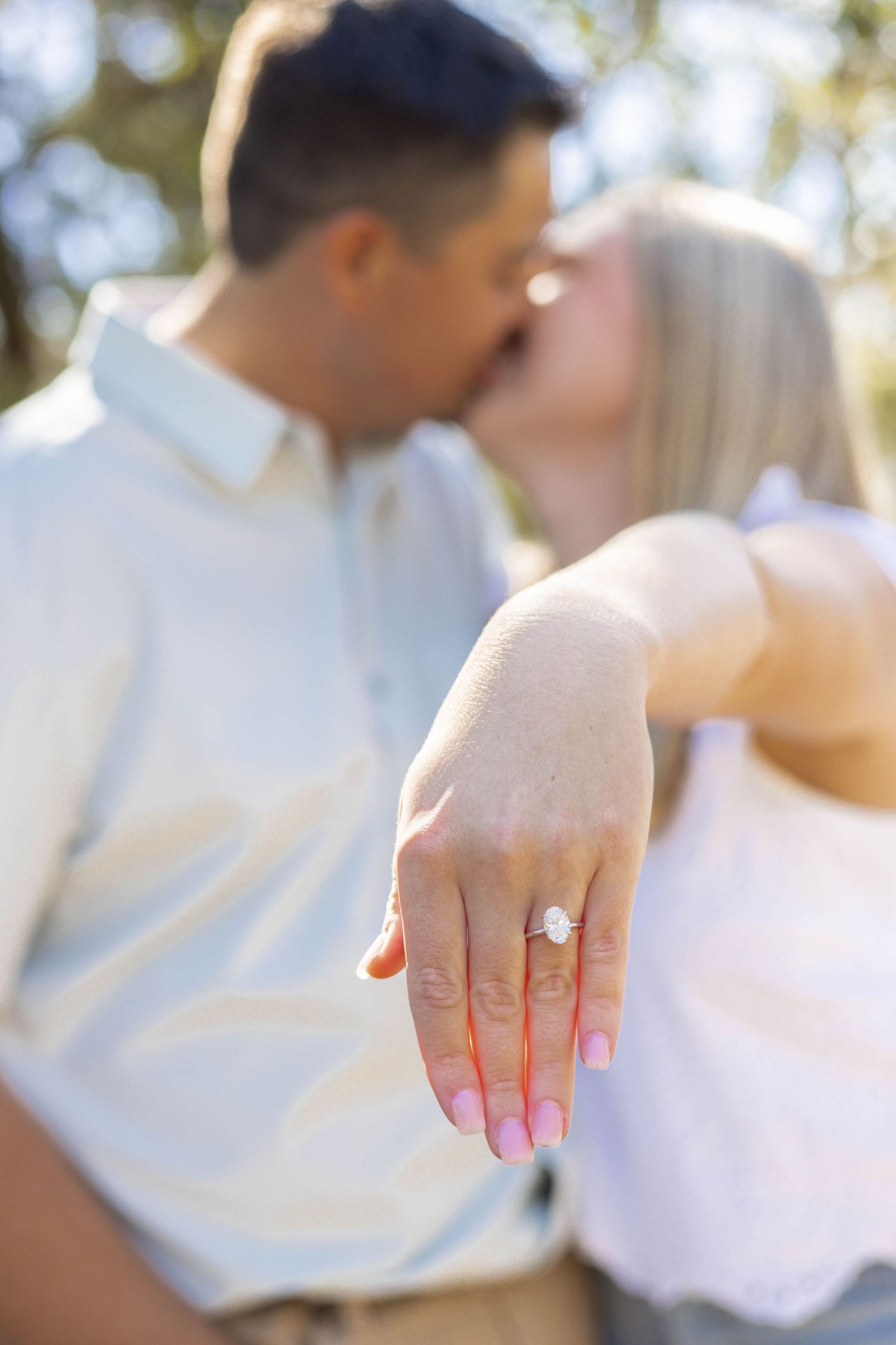 Close-up shot of a newly engaged hand showing off a sparkling engagement ring.