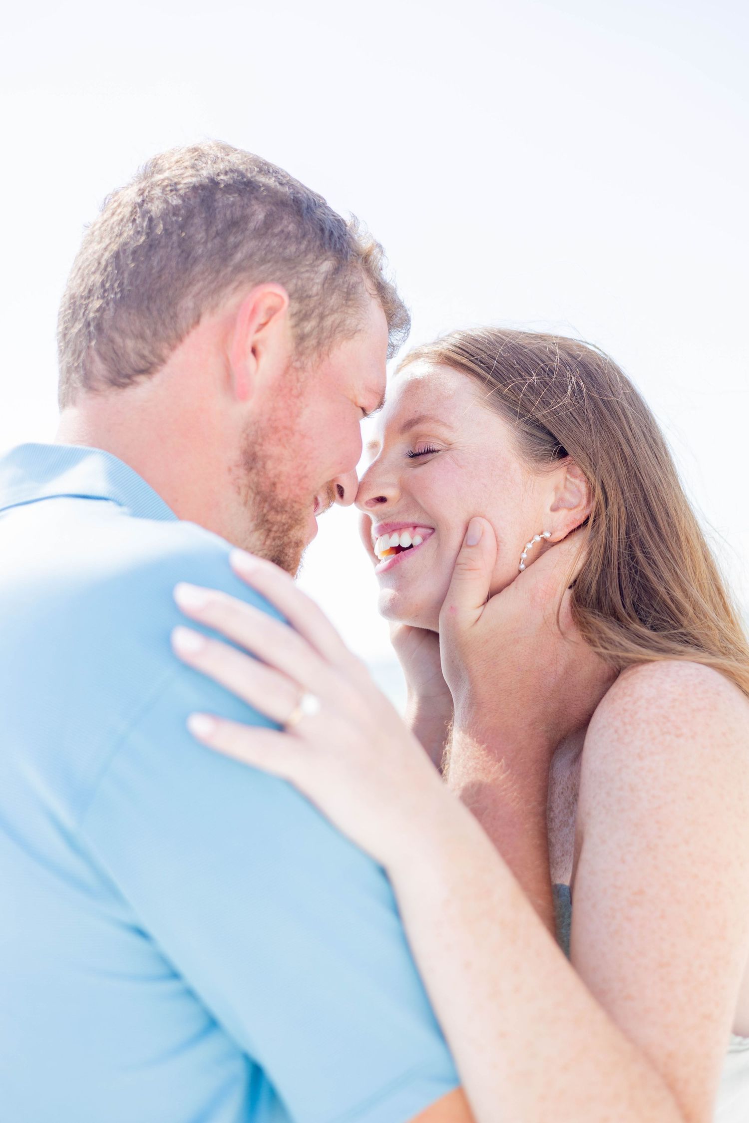 Romantic couple sharing an intimate moment on a bright sunny day.
