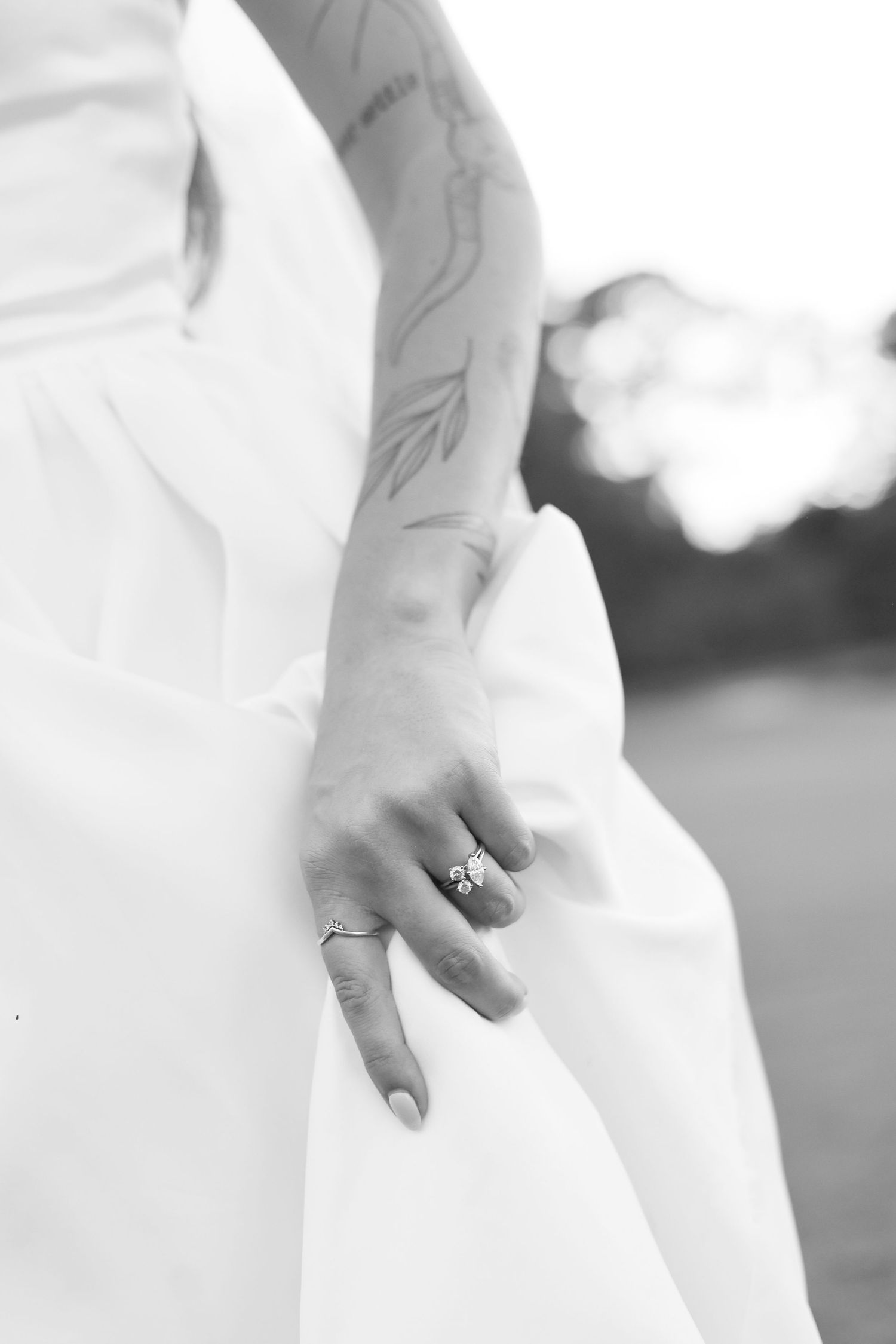 Minimalist black and white close-up details of wedding dress and jewelry.