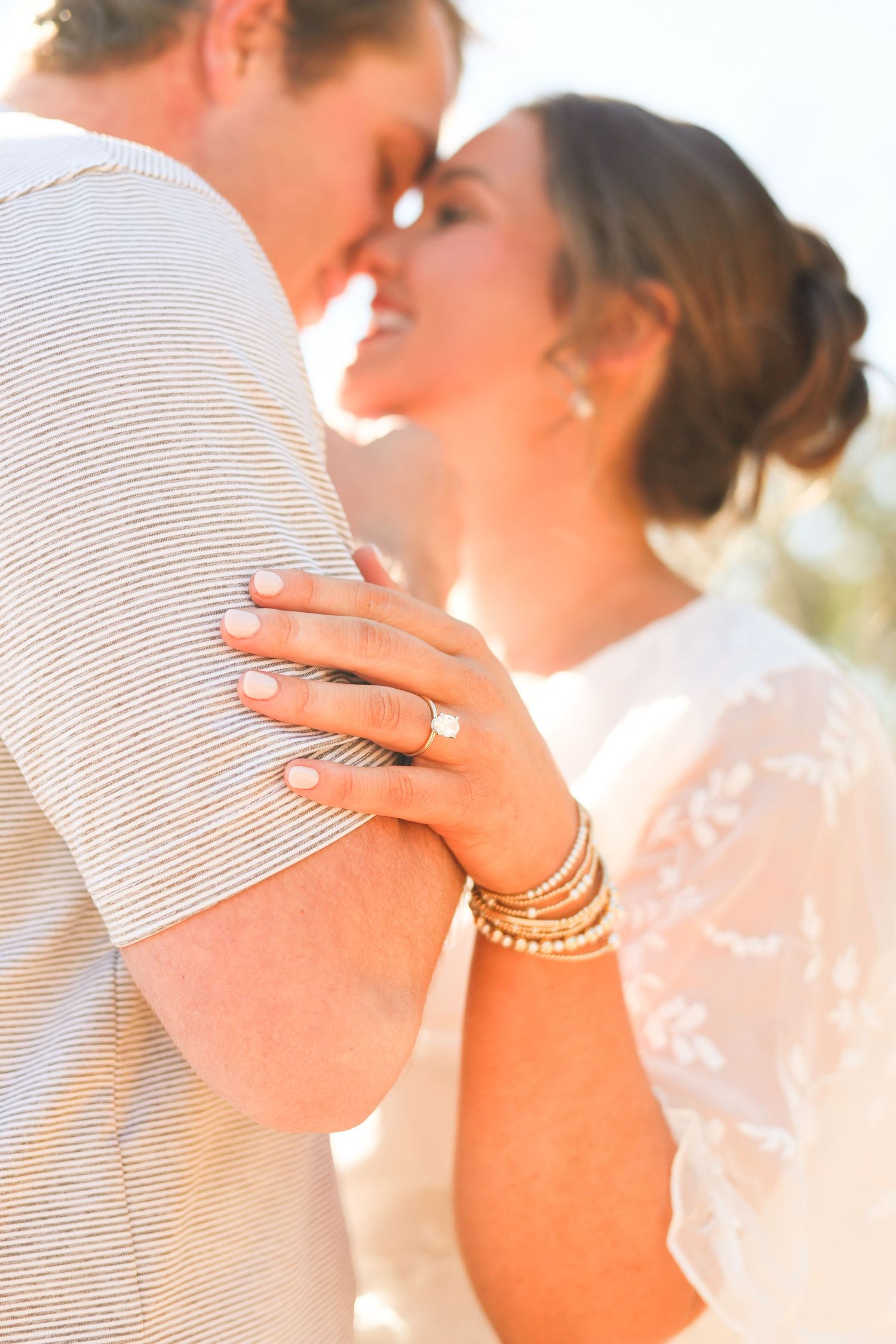 A close-up series of romantic wedding photos showing a couple embracing in soft golden sunlight.