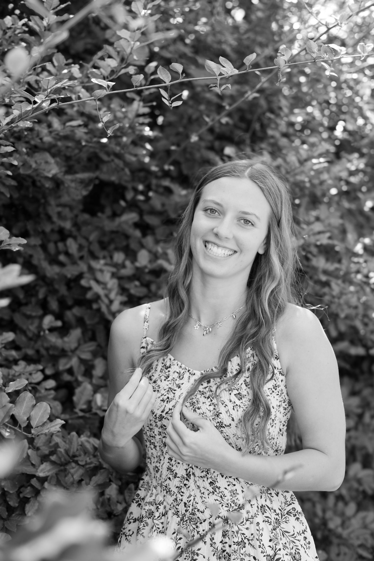 Black and white photos capturing candid laughing moments in garden setting.