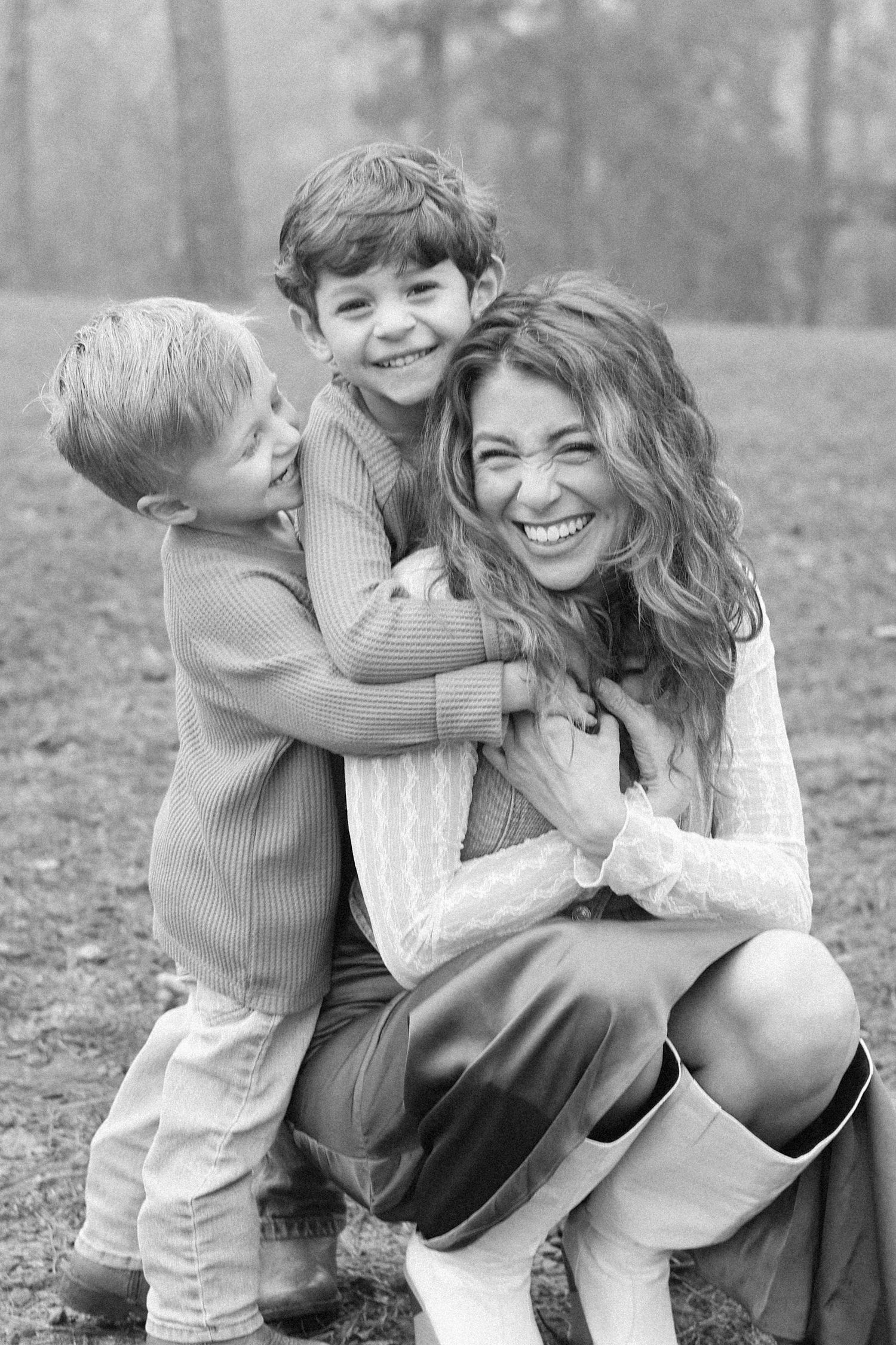 A heartwarming black and white photo sequence shows playful moments between parent and child outdoors in autumn.