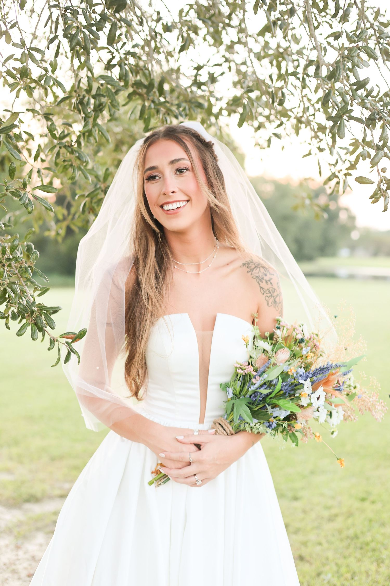 A bridal portrait series showing a white wedding dress and veil against a sunlit outdoor backdrop with trees.