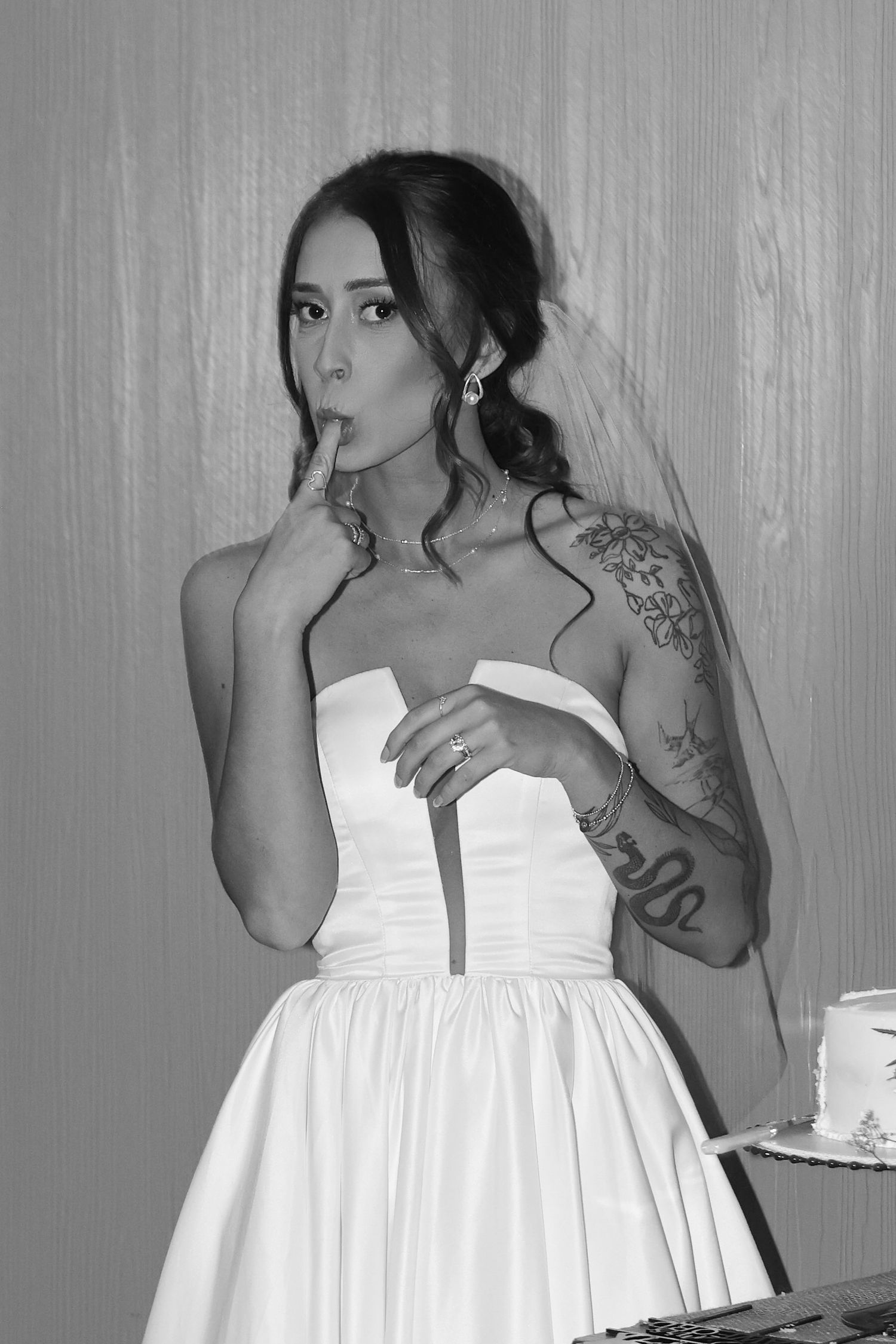 Close-up shots of a bride in a white strapless dress with visible tattoos.