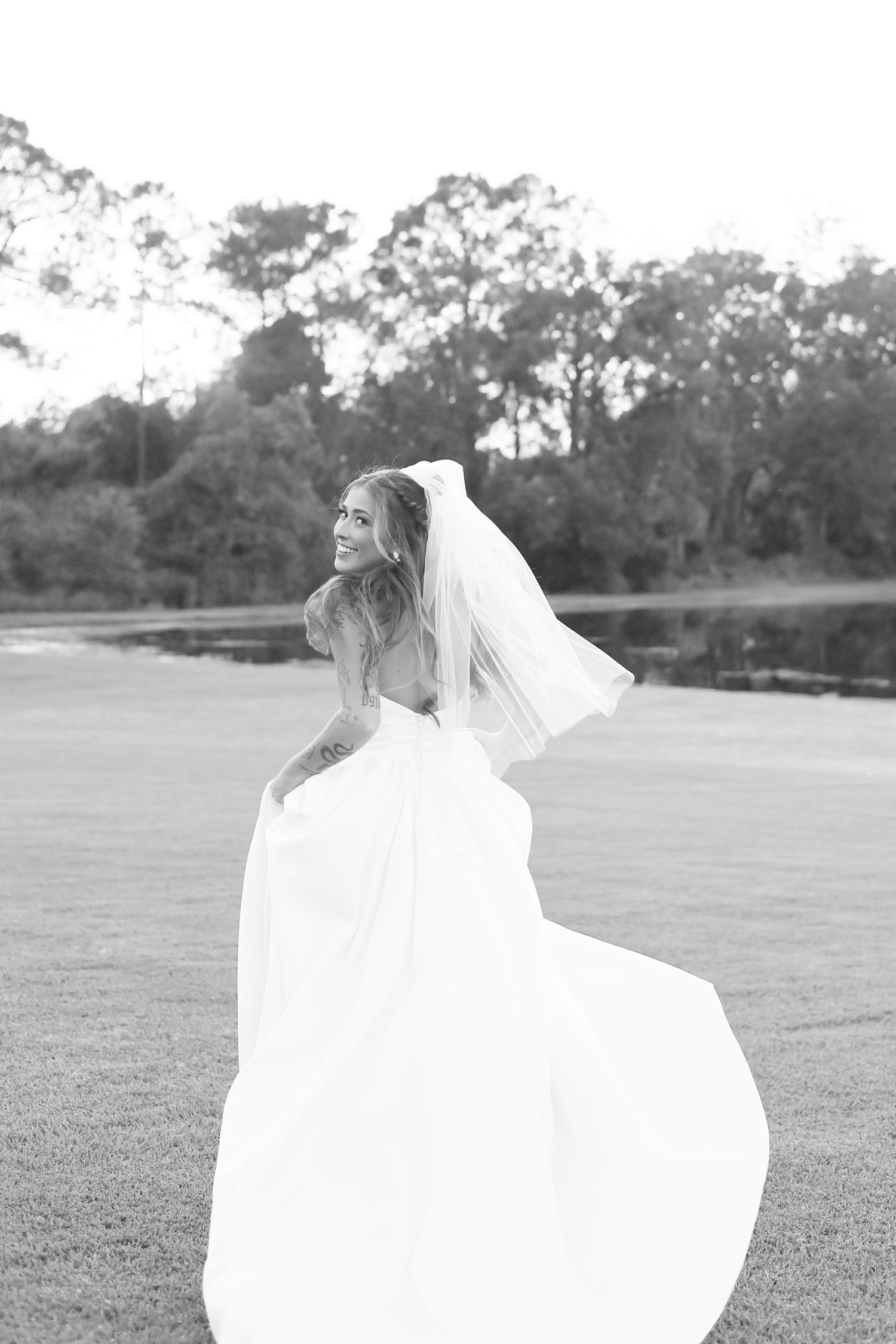 Artistic black and white series of flowing wedding dress movement in outdoor setting.