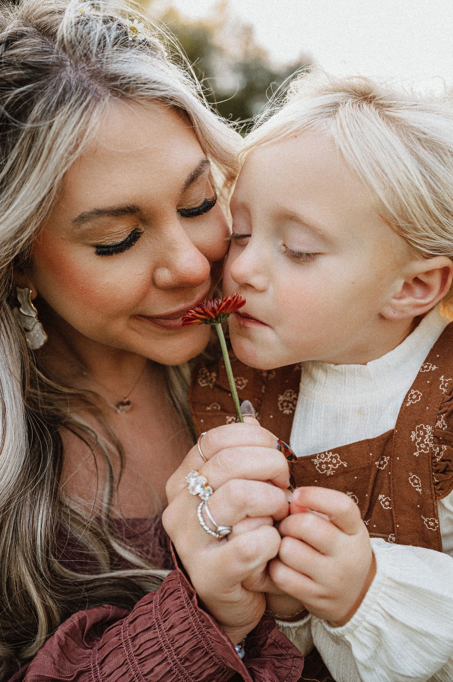 Close-up shots of tender moments shared between parent and child with a flower.