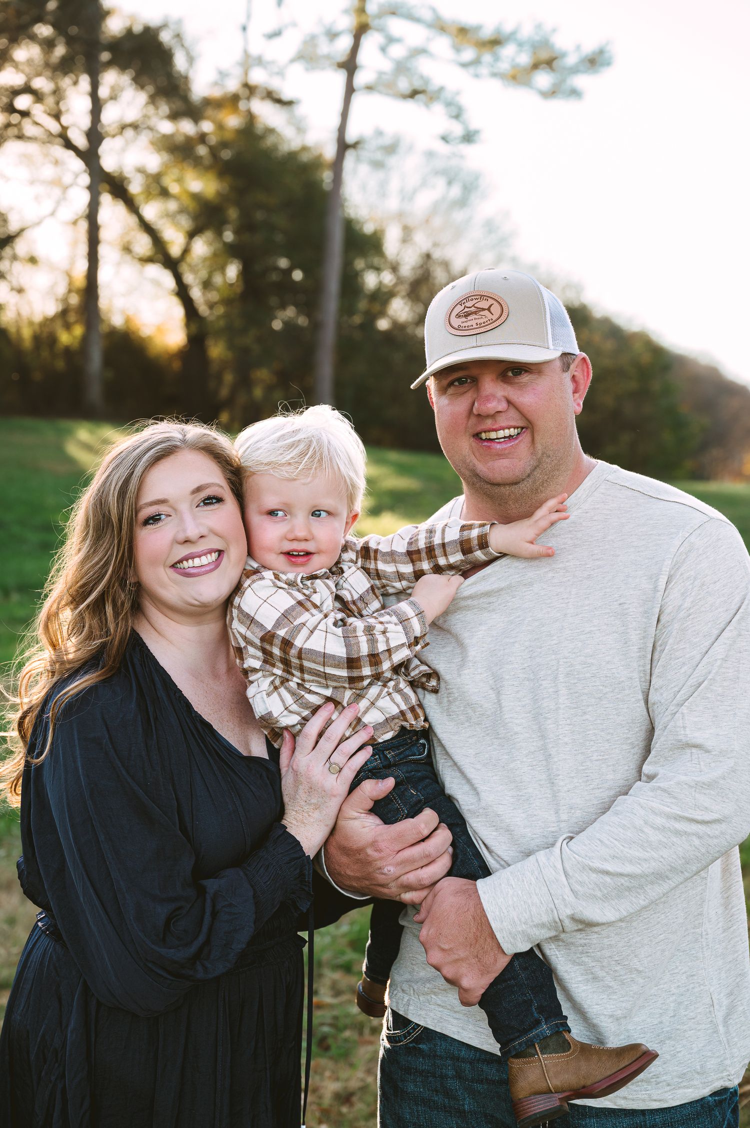 Candid outdoor family portraits showing playful interactions at sunset.