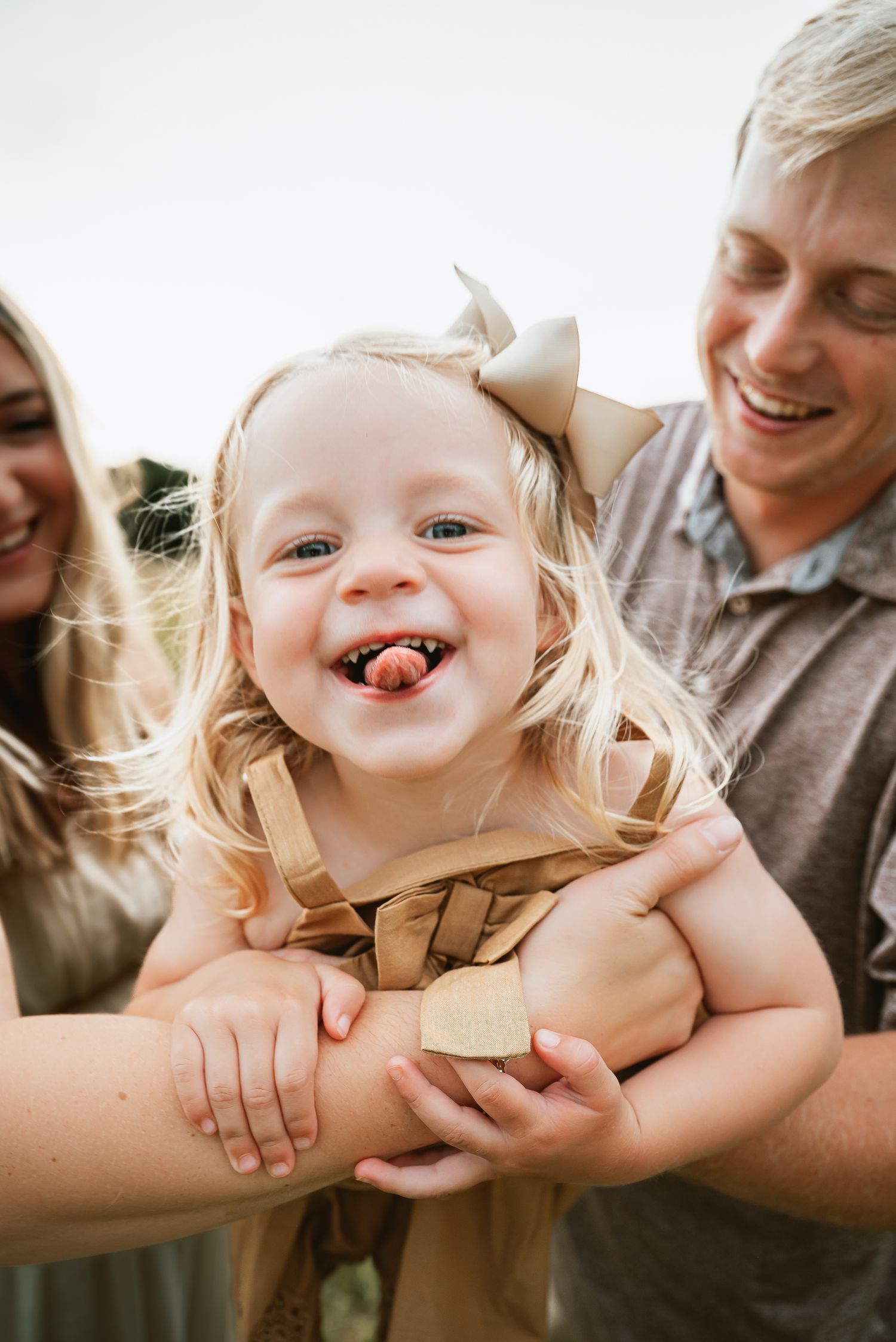 Playful candid moments between family members in natural lighting.
