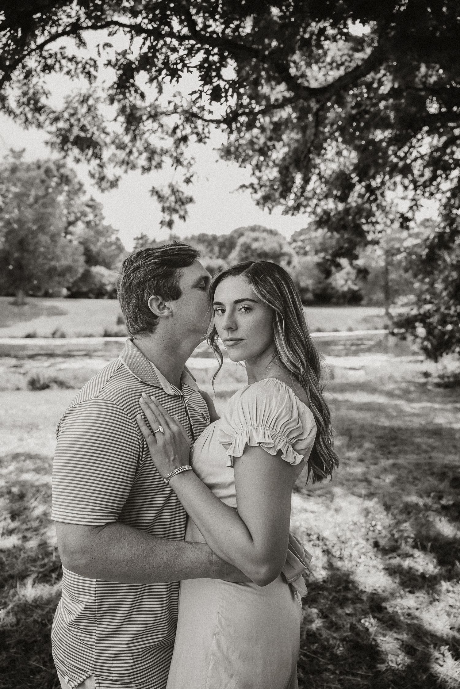 Black and white portrait series of couple sharing intimate moments outdoors.