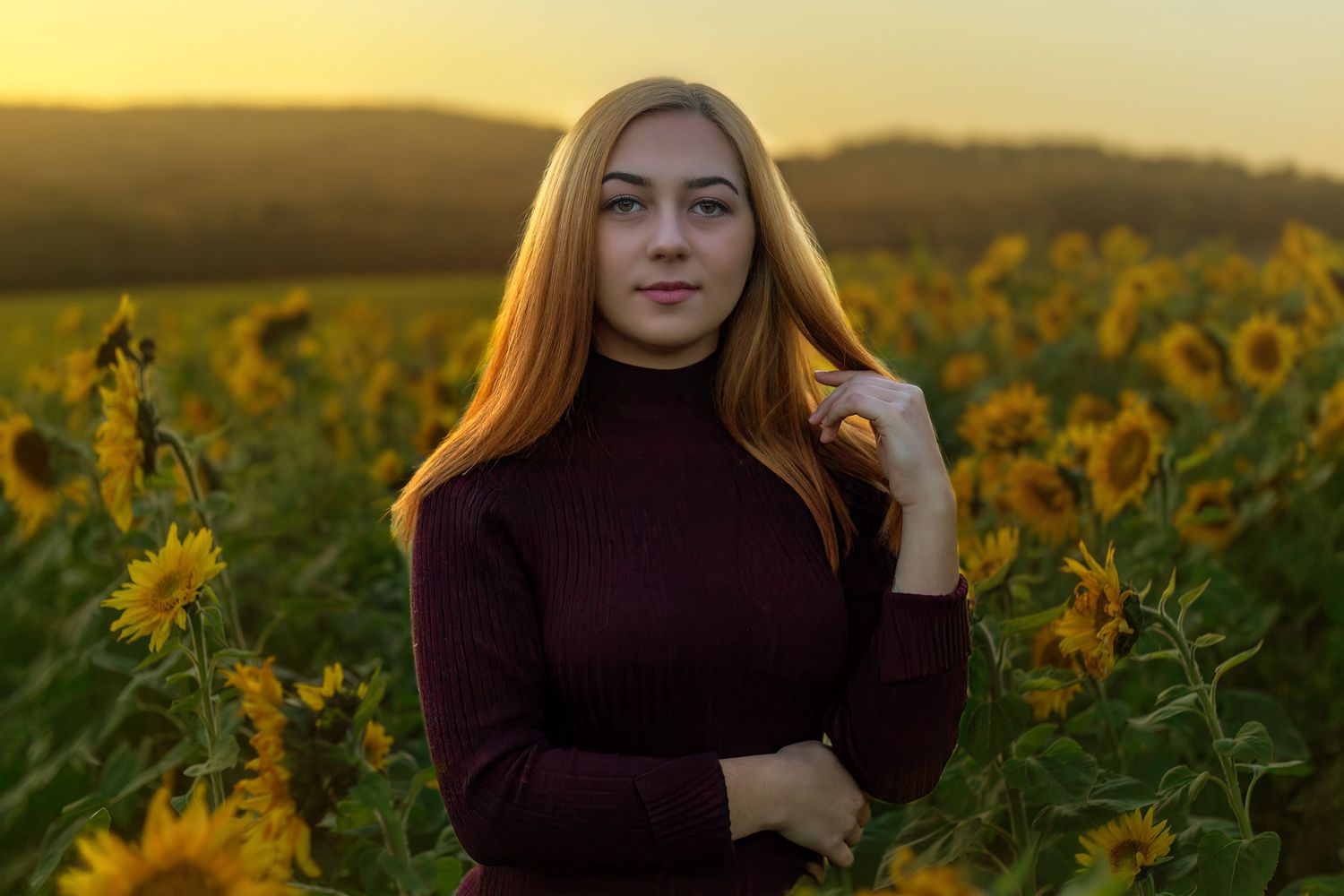 Portrait session in golden sunflower field during sunset.