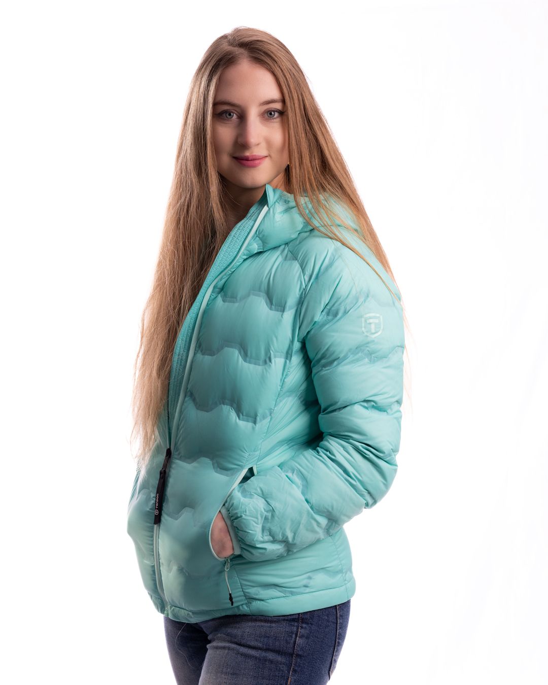 Model wearing a mint green puffer jacket with jeans against white background in multiple poses.