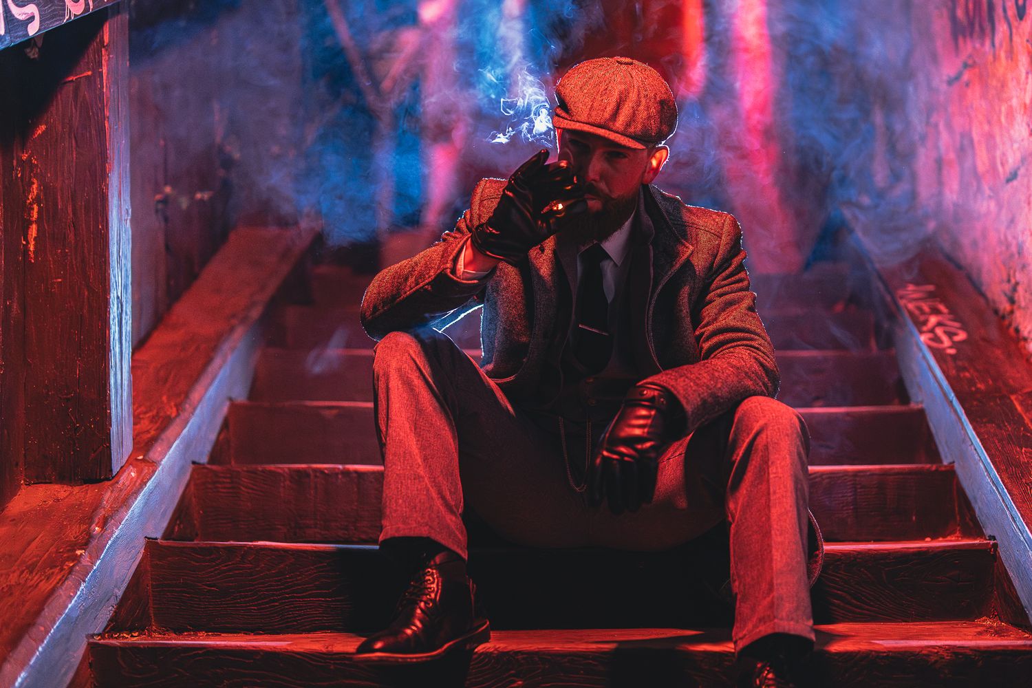 Figure sitting on neon-lit steps with vibrant pink and blue lighting effects.
