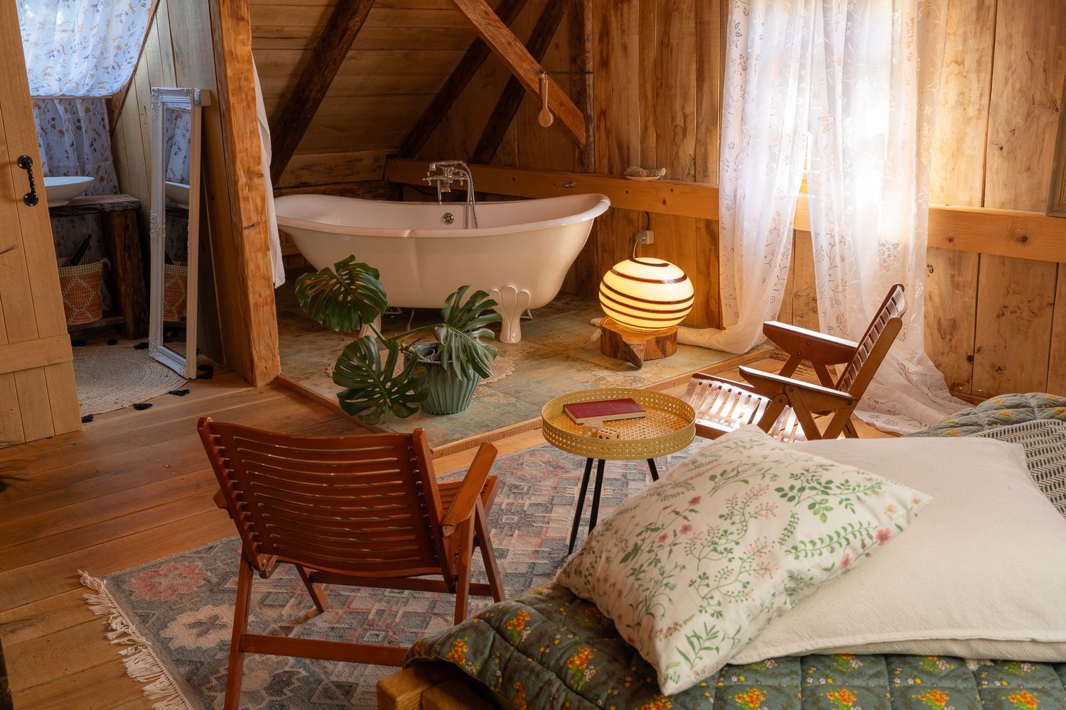 Charming attic room interior with wooden architecture and comfortable seating area.