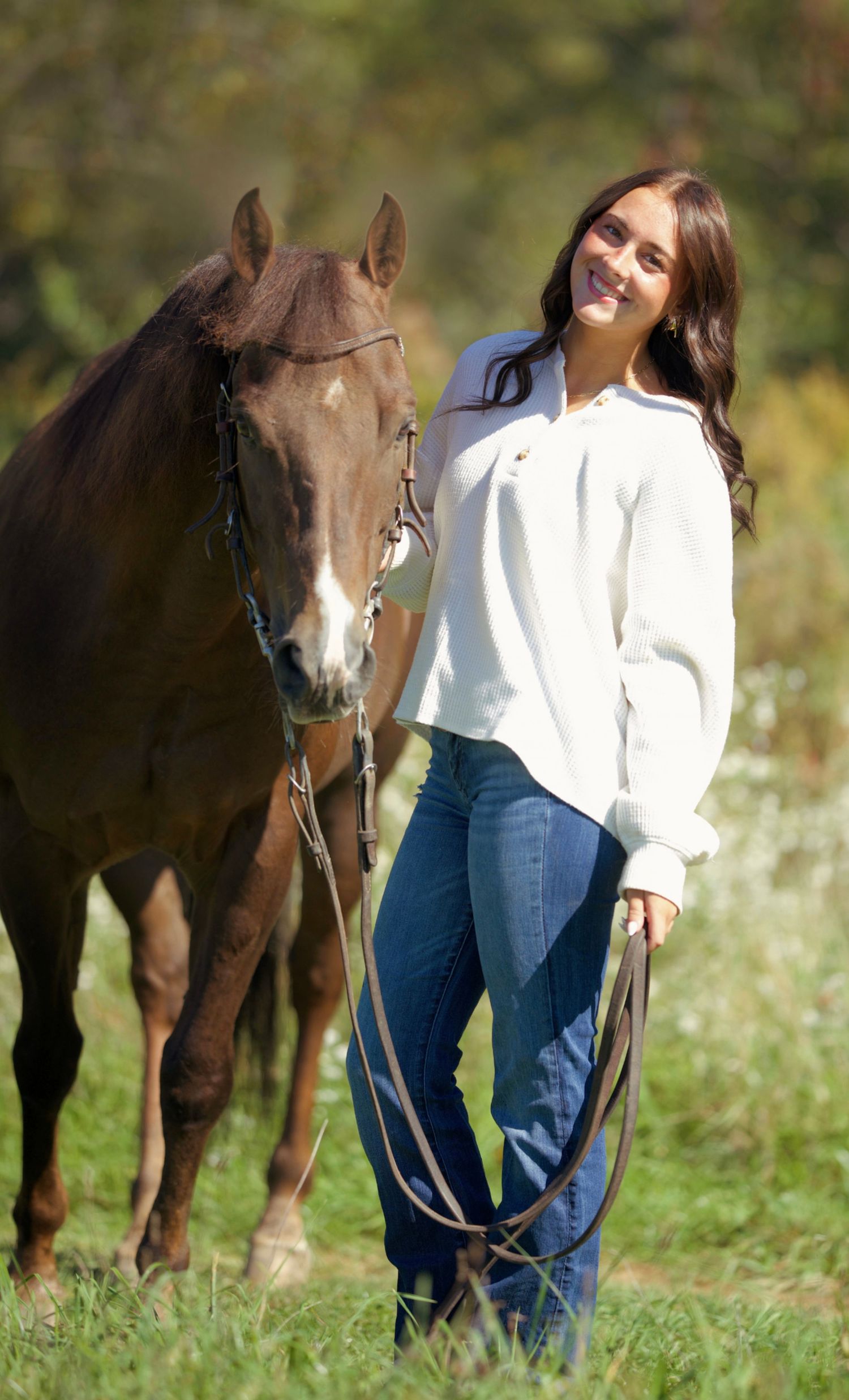 A girl and her horse in a field